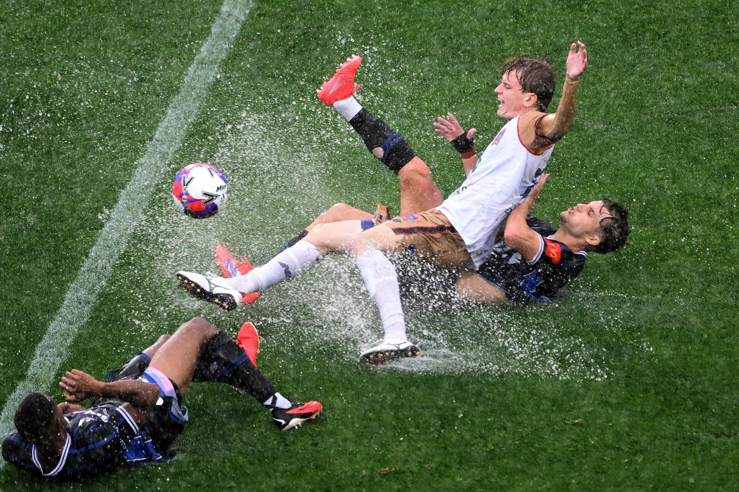 El delantero de los Newcastle Jets, Benjamin Gibson, es derribado por Callan Elliot del Auckland FC durante el partido de la A-League en Auckland.