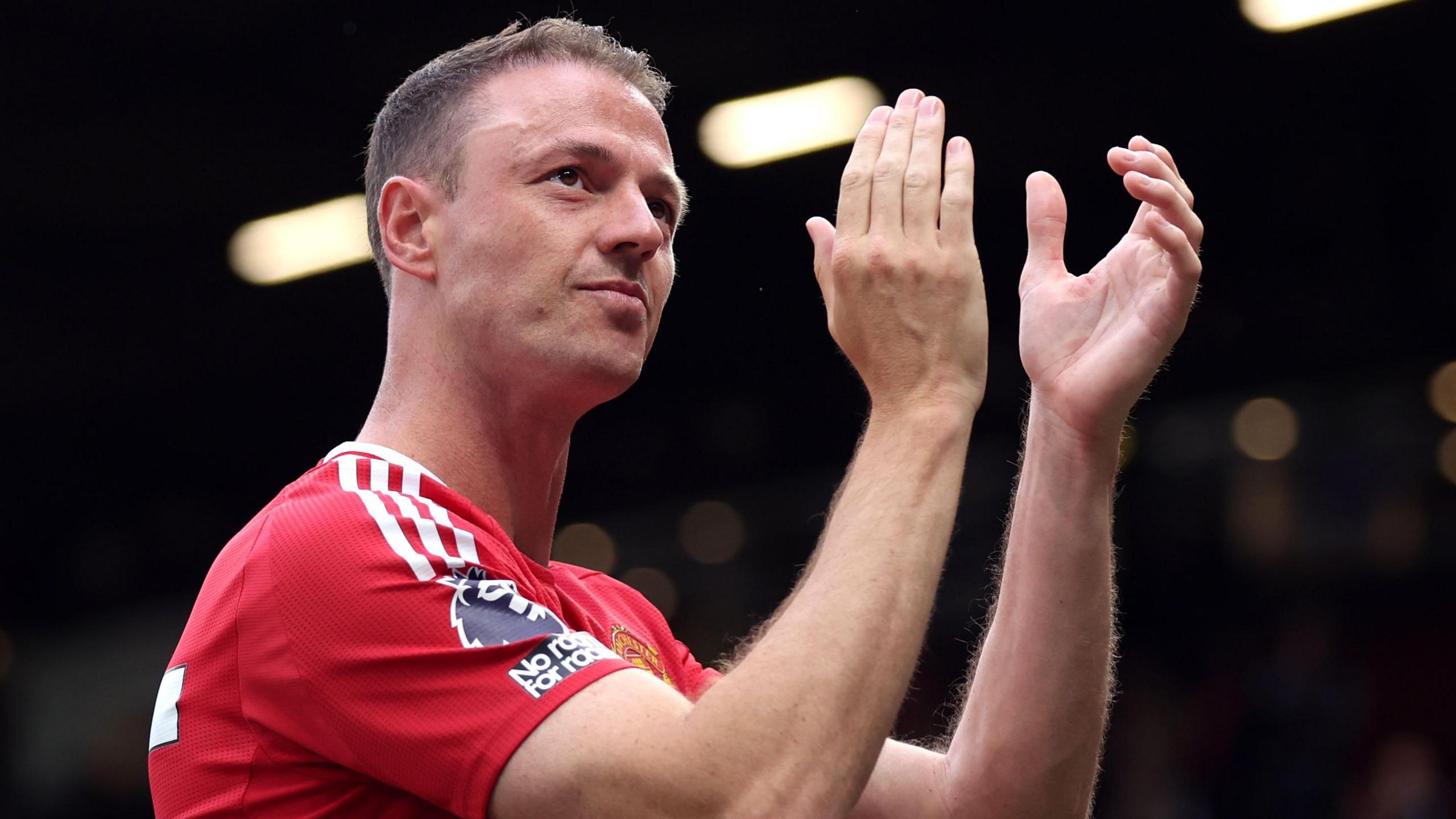 Jonny Evans applauding fans