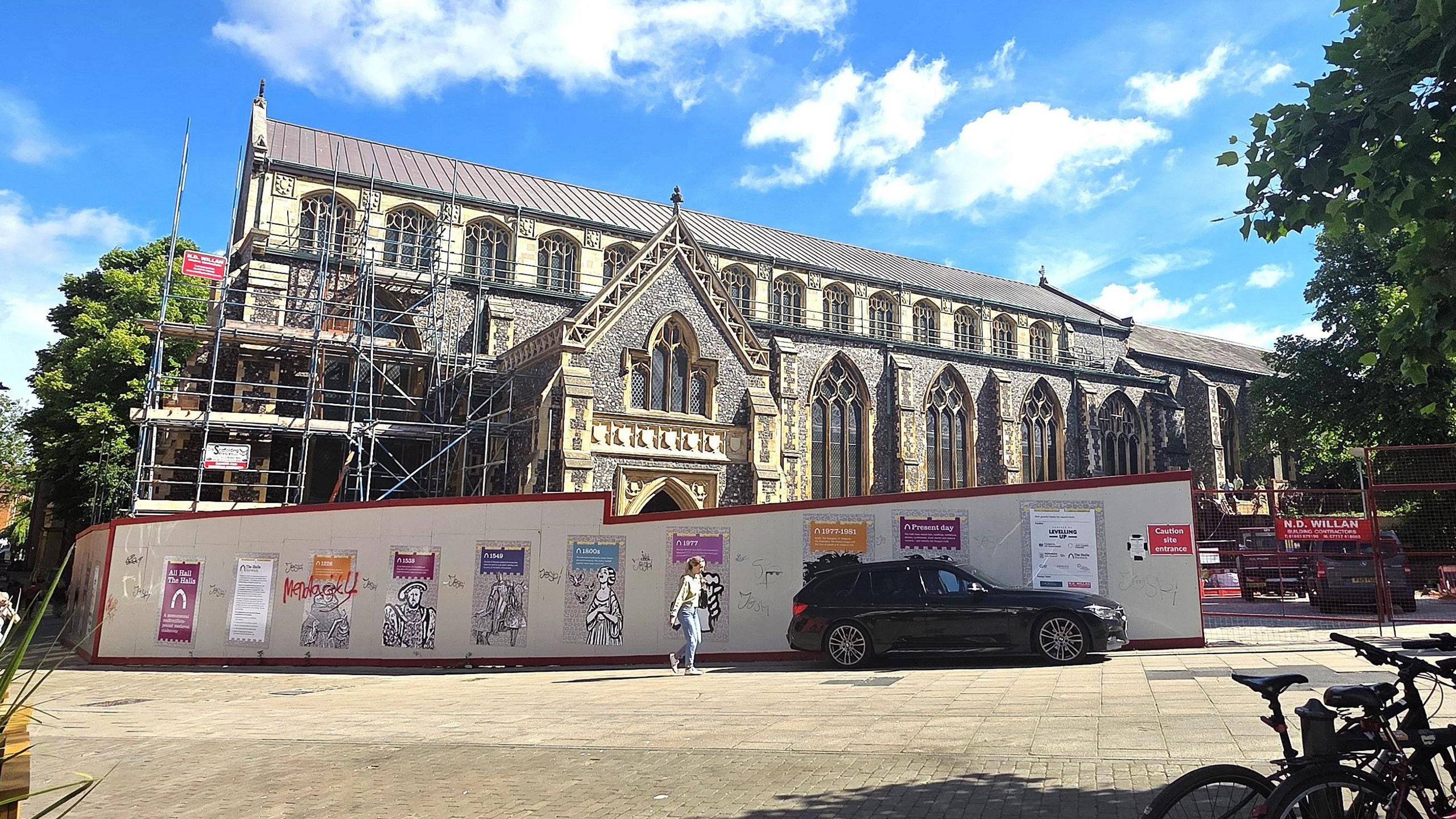 We can see St Andrews Hall - a 14th century building partially covered with scaffolding. In front of it we can see a temporary wall blocking off access, so that construction work can take place.