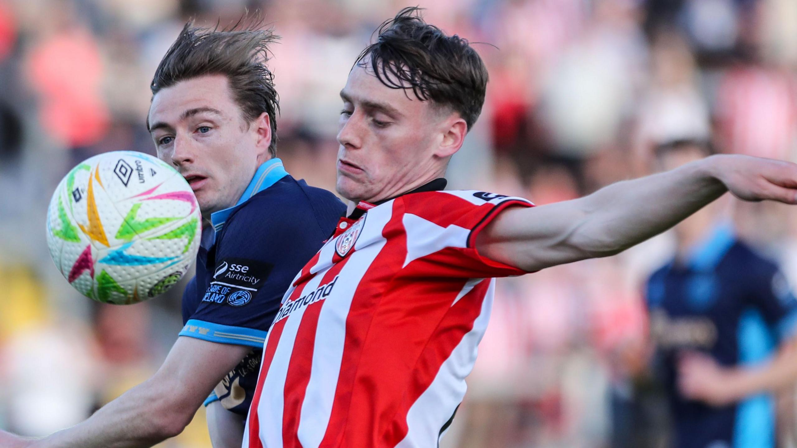 Derry City's Conor Barr in action against Daniel Kelly of Shelbourne