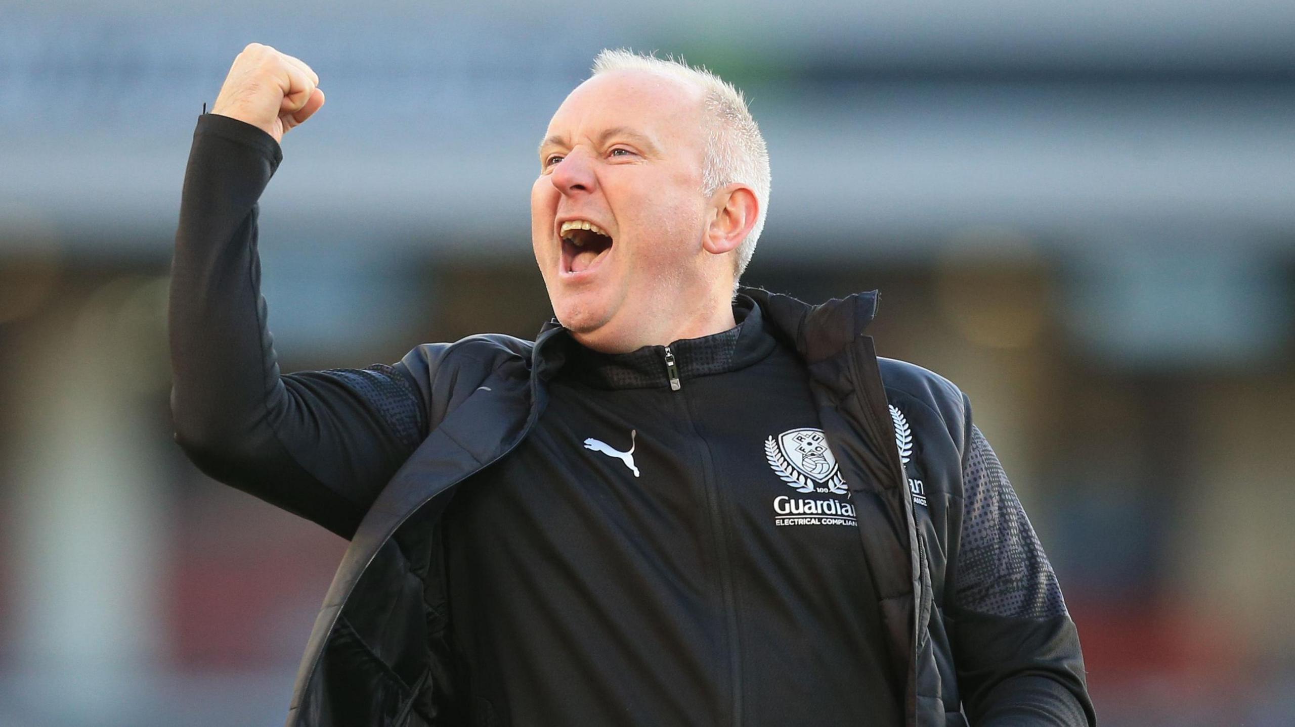 Matt Hamshaw celebrating Rotherham's recent win at Barnsley with his right fist clenched as he punches the air.