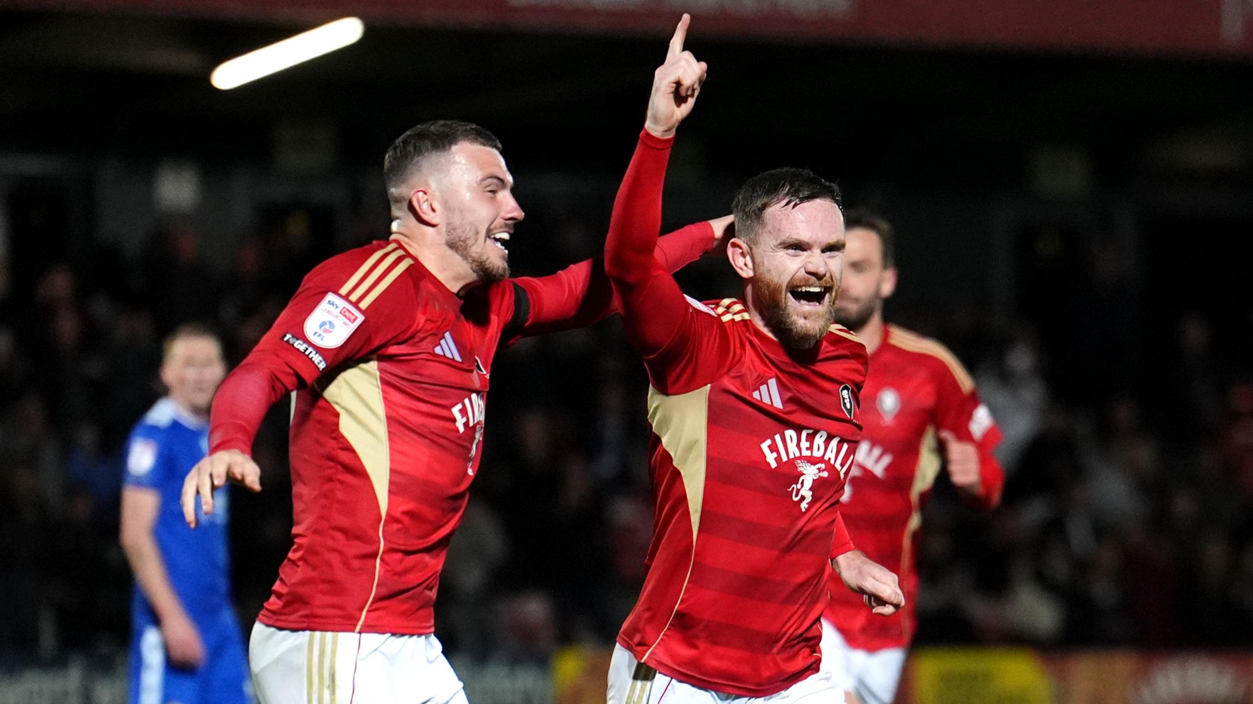 Salford City's Oliver Turton (right) celebrates scoring his side's second goal against Bromley