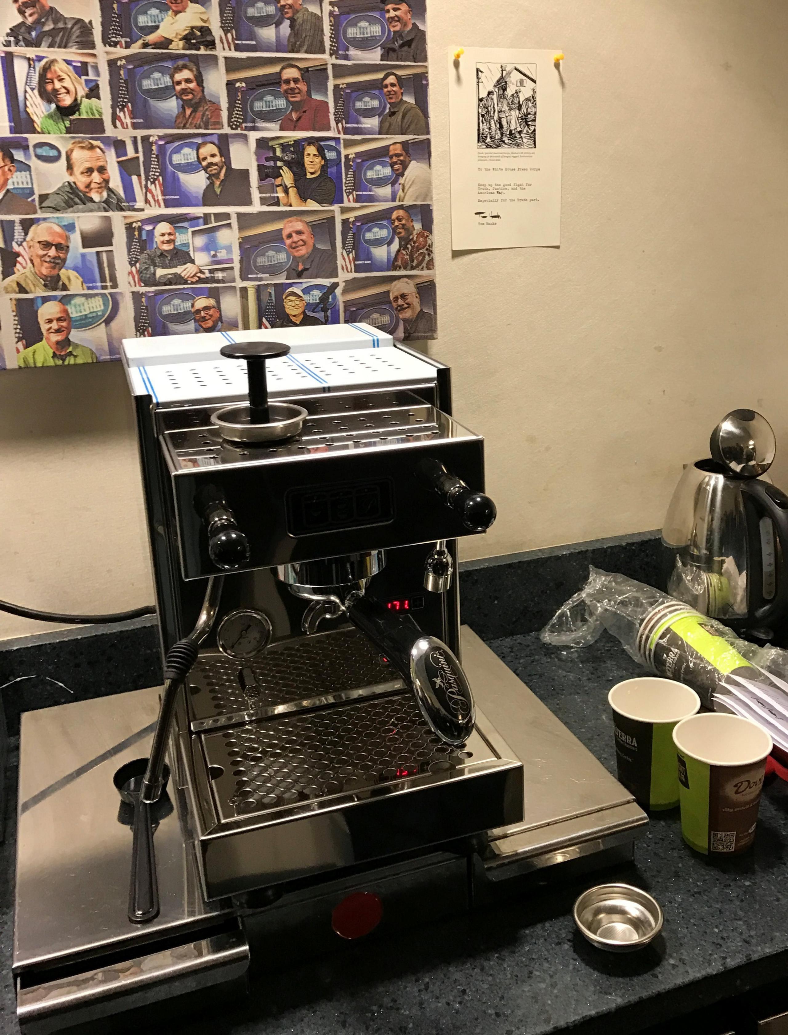 A brand new coffee machine and an attached note on the wall from actor Tom Hanks to the White House Press Corps are seen in the press room of the White House in Washington