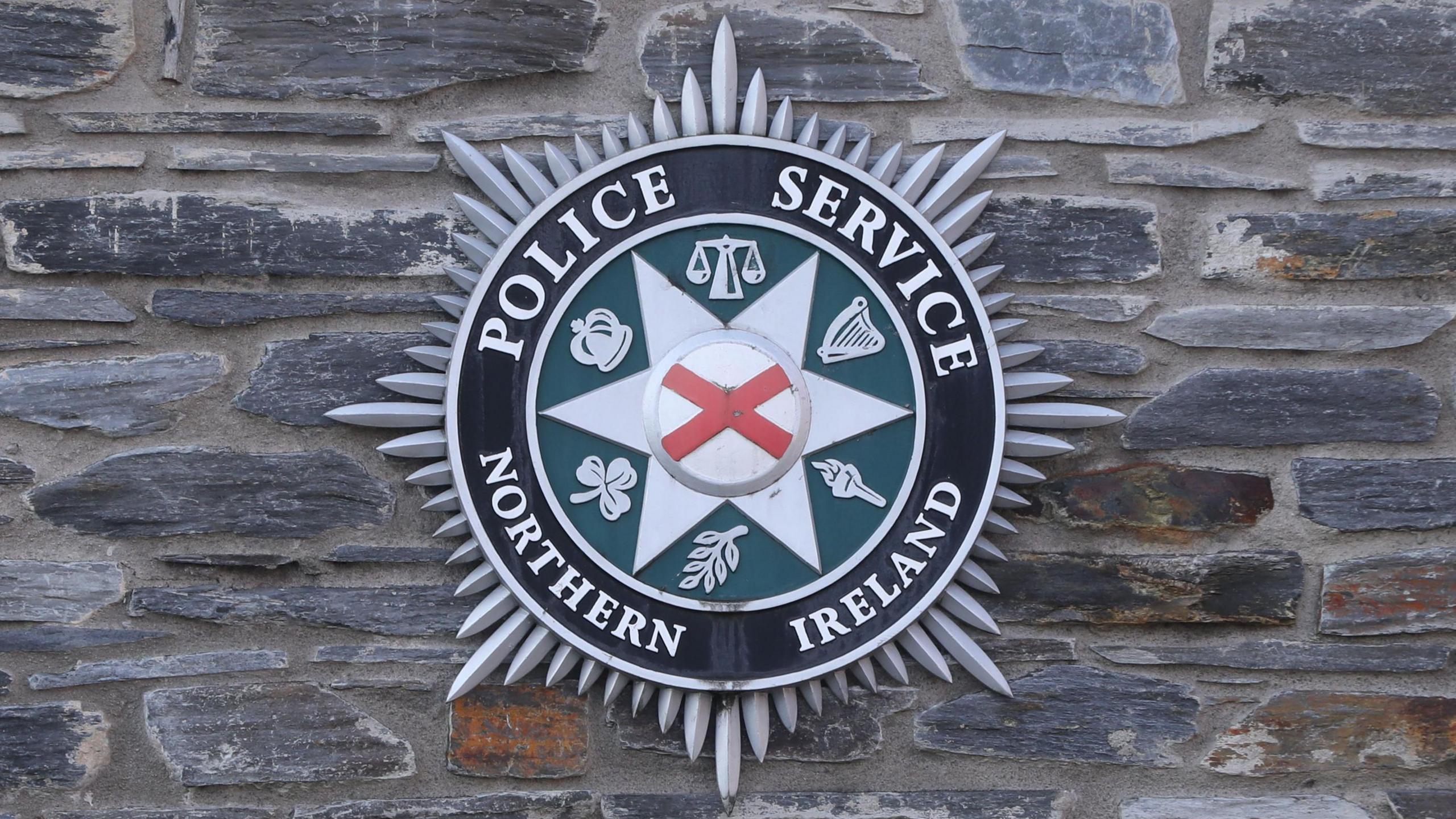 PSNI logo badge on wall