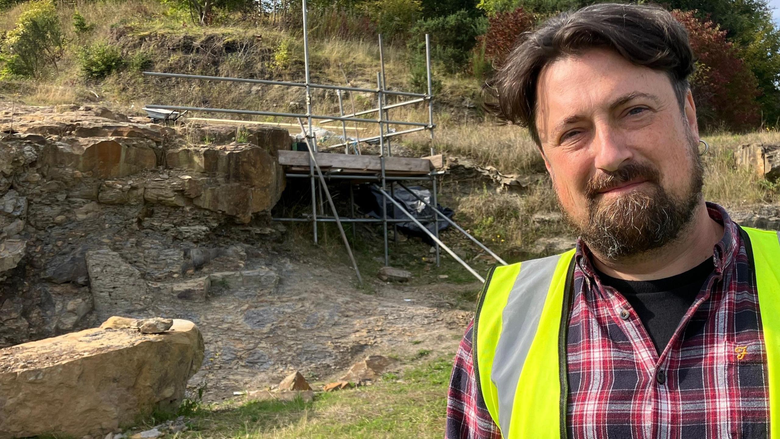 Dr Tim Astrop smiling at the camera at the dig site