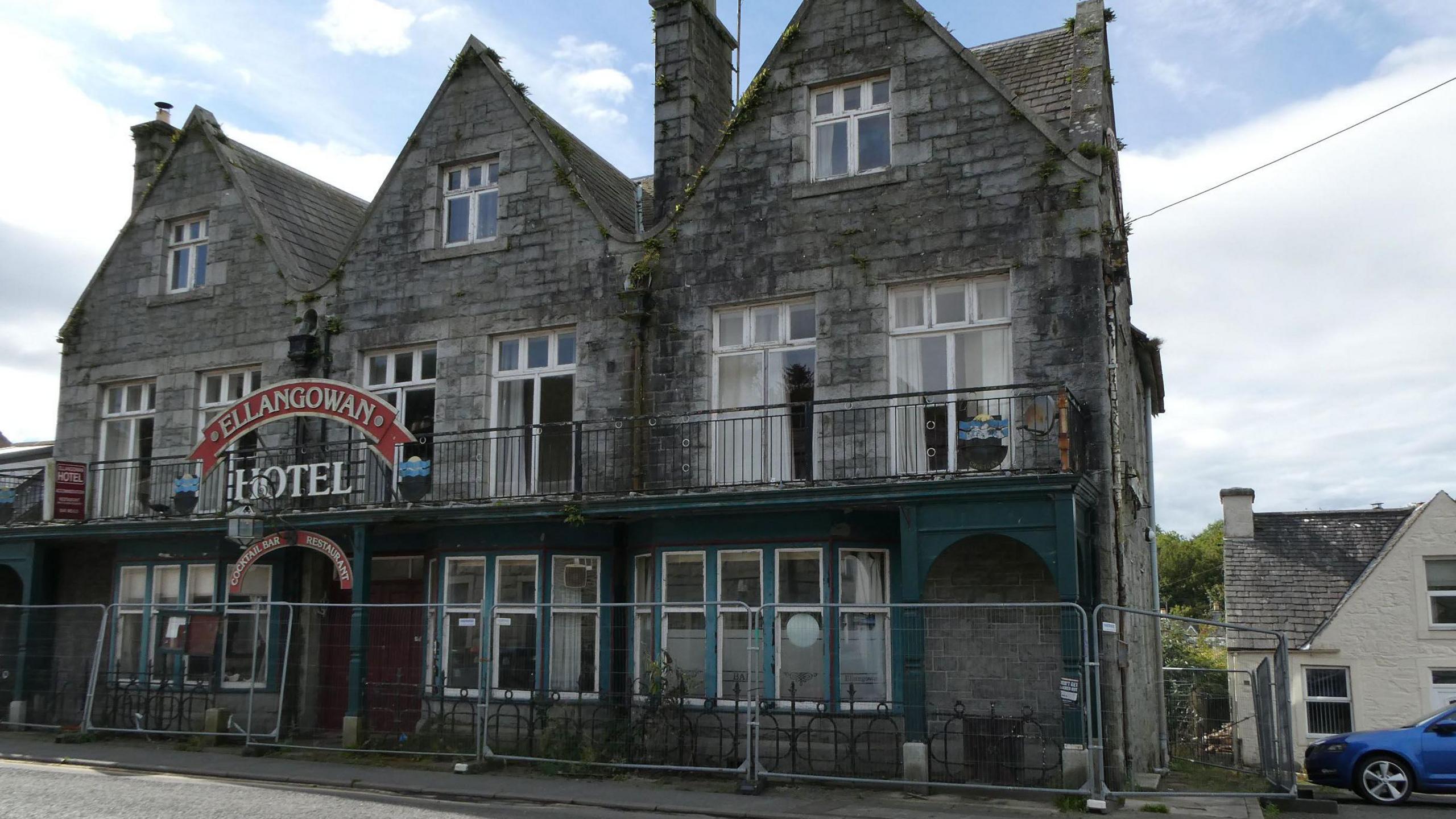 The same hotel but with barriers outside to avoid entrance and it looks run down after some years of neglect