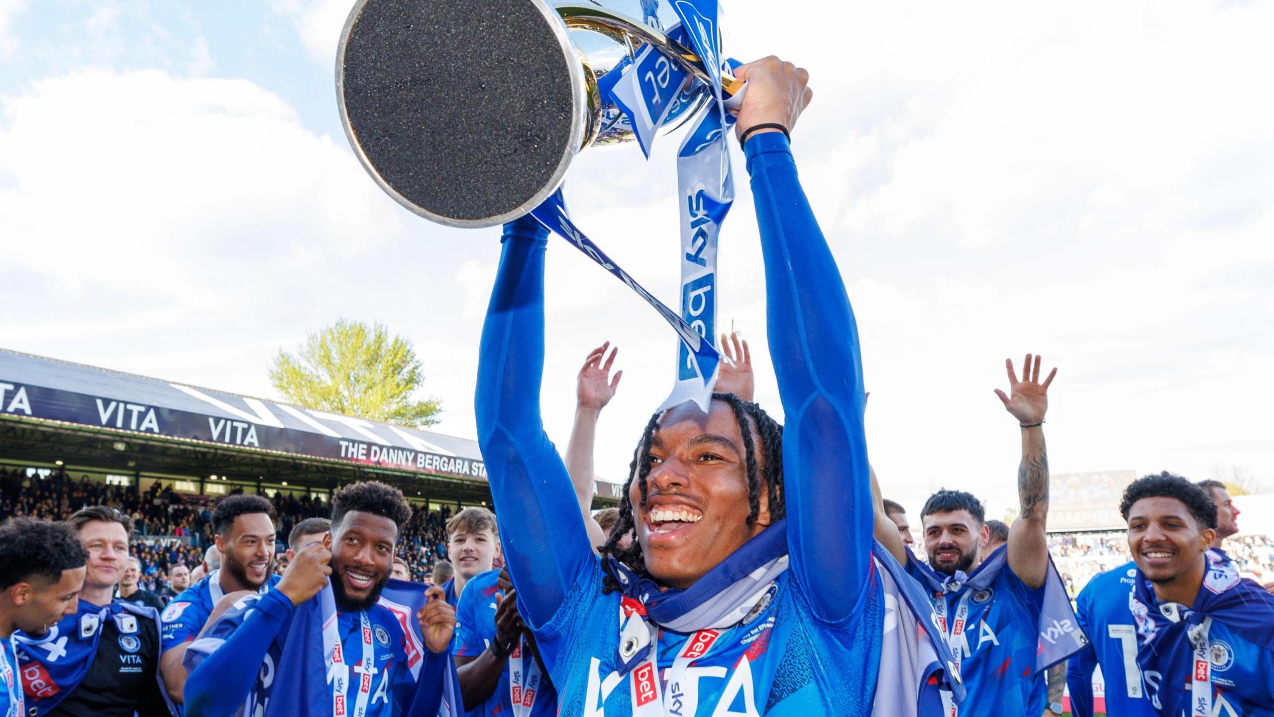 Rico Richards helps to celebrate Stockport County's League Two title win at Edgeley Park