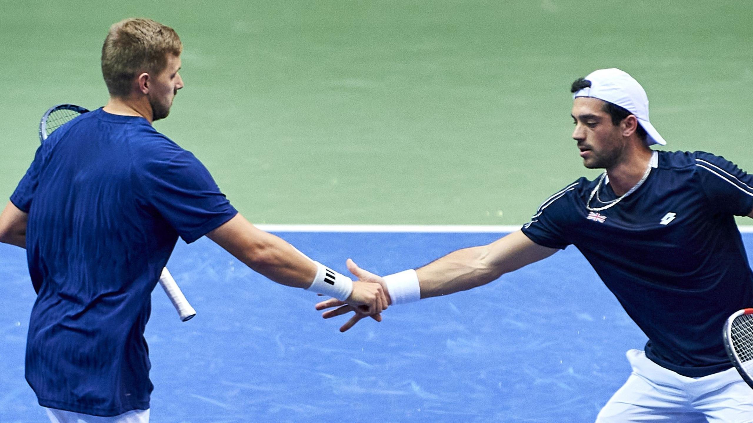 Julian Cash and Lloyd Glasspool shake hands during Davis Cup doubles match against Poland