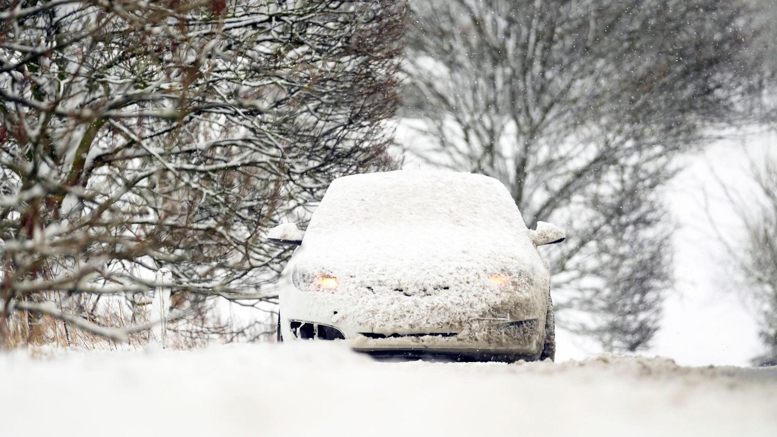 A snow covered car on the A169 between Pickering and Whitby on the North York Moors