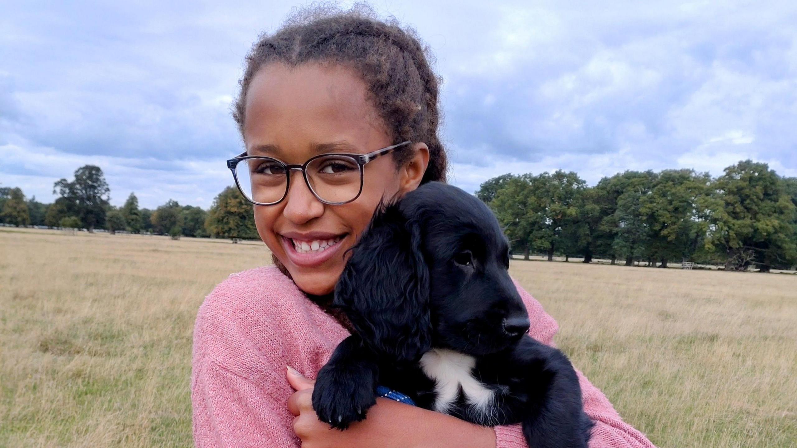 Anya cuddling a dog