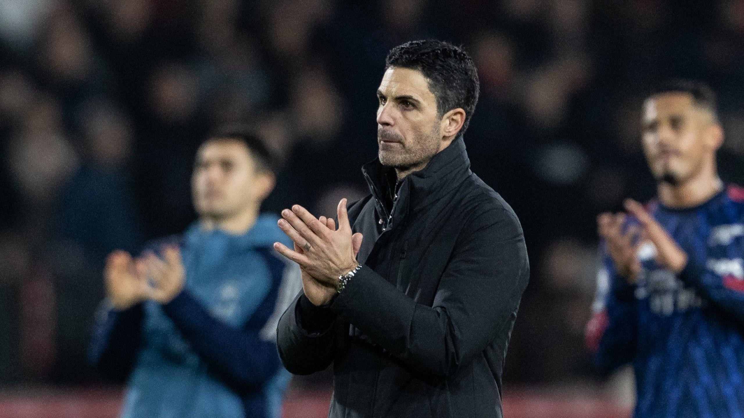 Mikel Arteta applauds fans at end of match while looking dejected