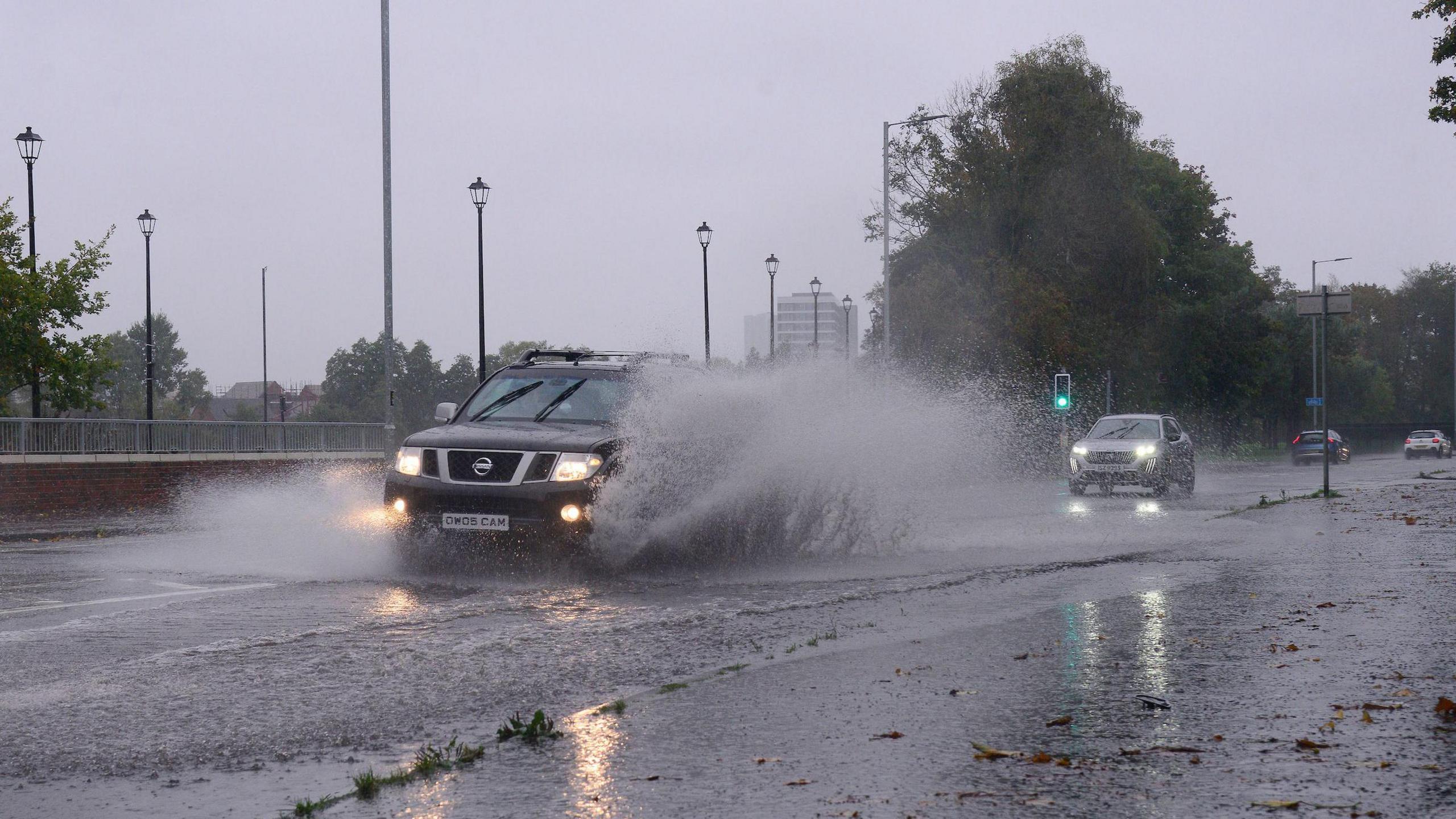 Cars driving through flood water. 