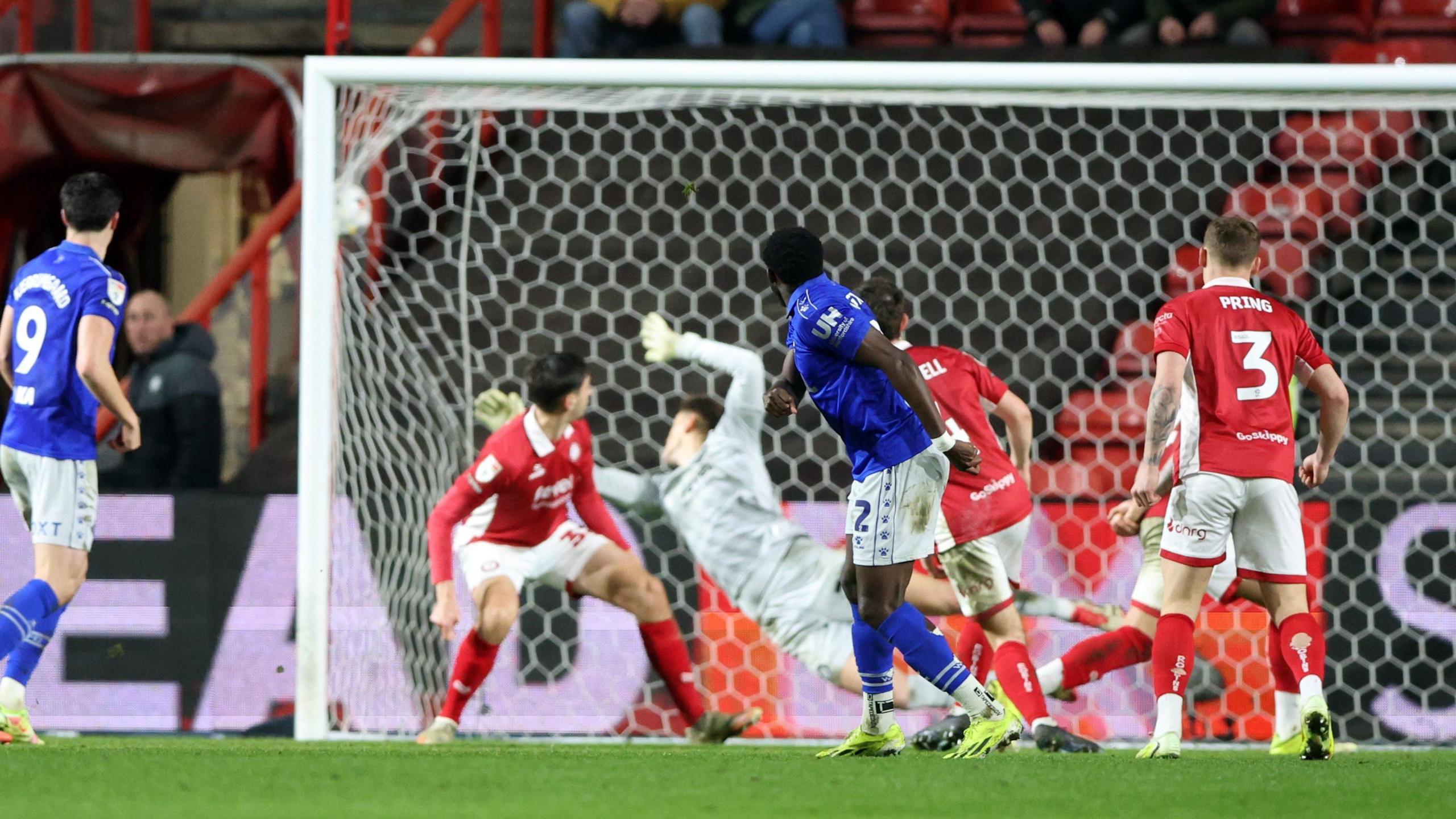 Jeremy Ngakia (centre) watches along with three Bristol City players as the ball flies into the top corner of the net for a goal