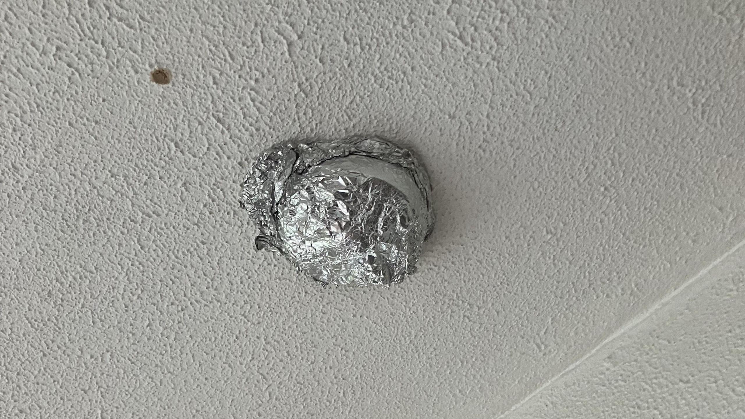 An image of the ceiling of the house in Brent, with the smoke alarm covered with aluminium foil.