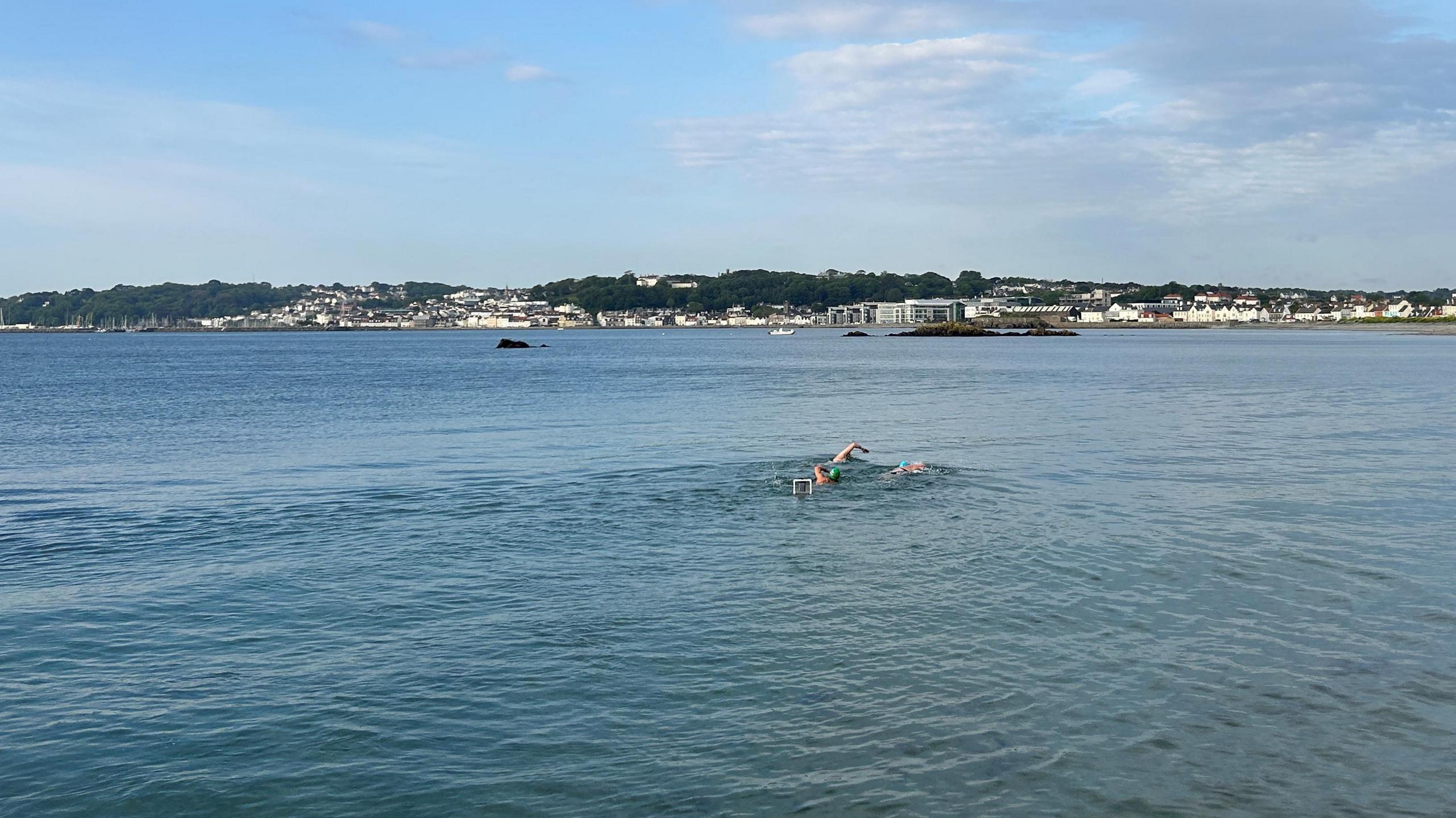 Swimmers with St Peter Port in the background