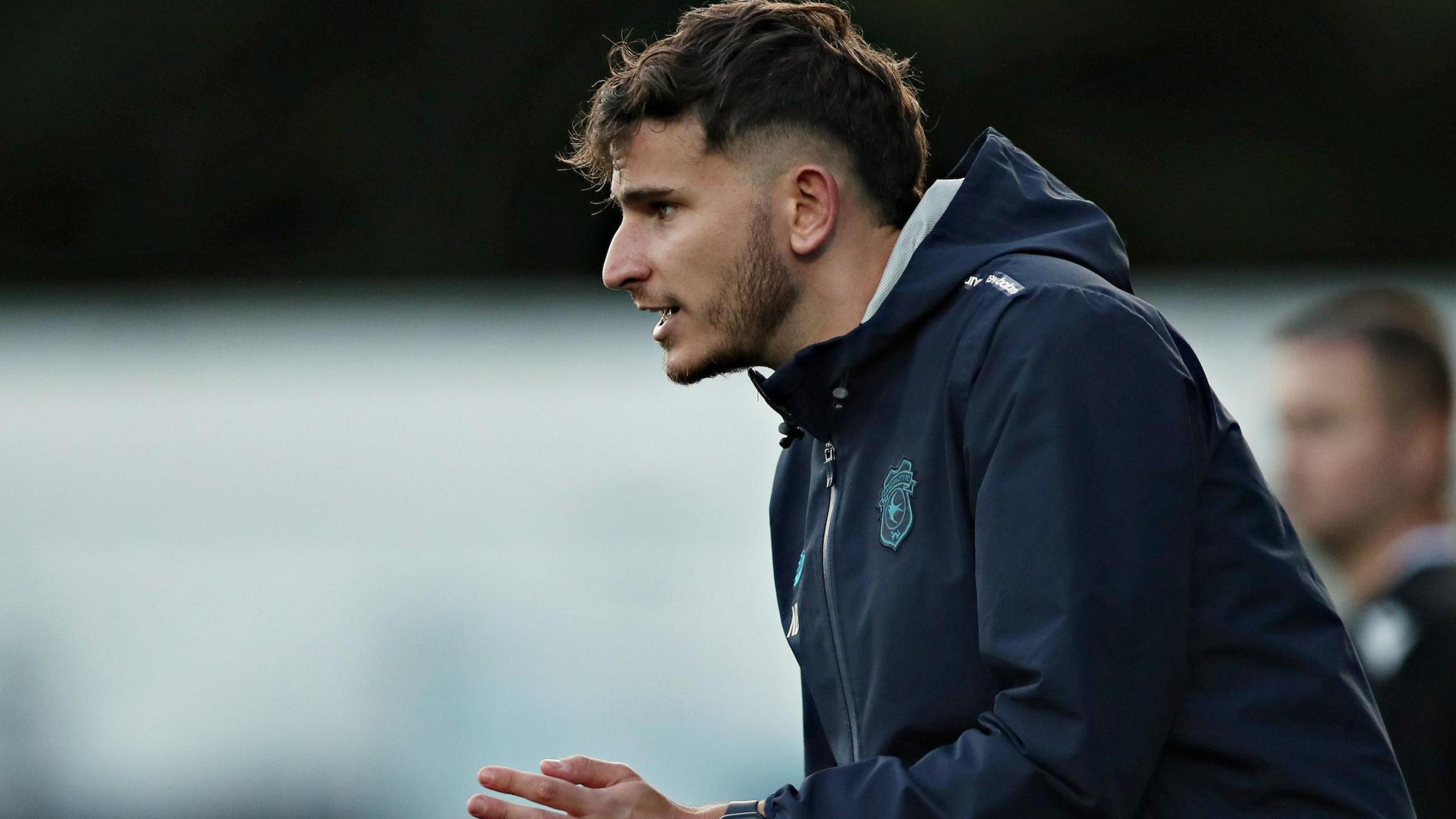 Noah Bushby encourages his players from the touchline