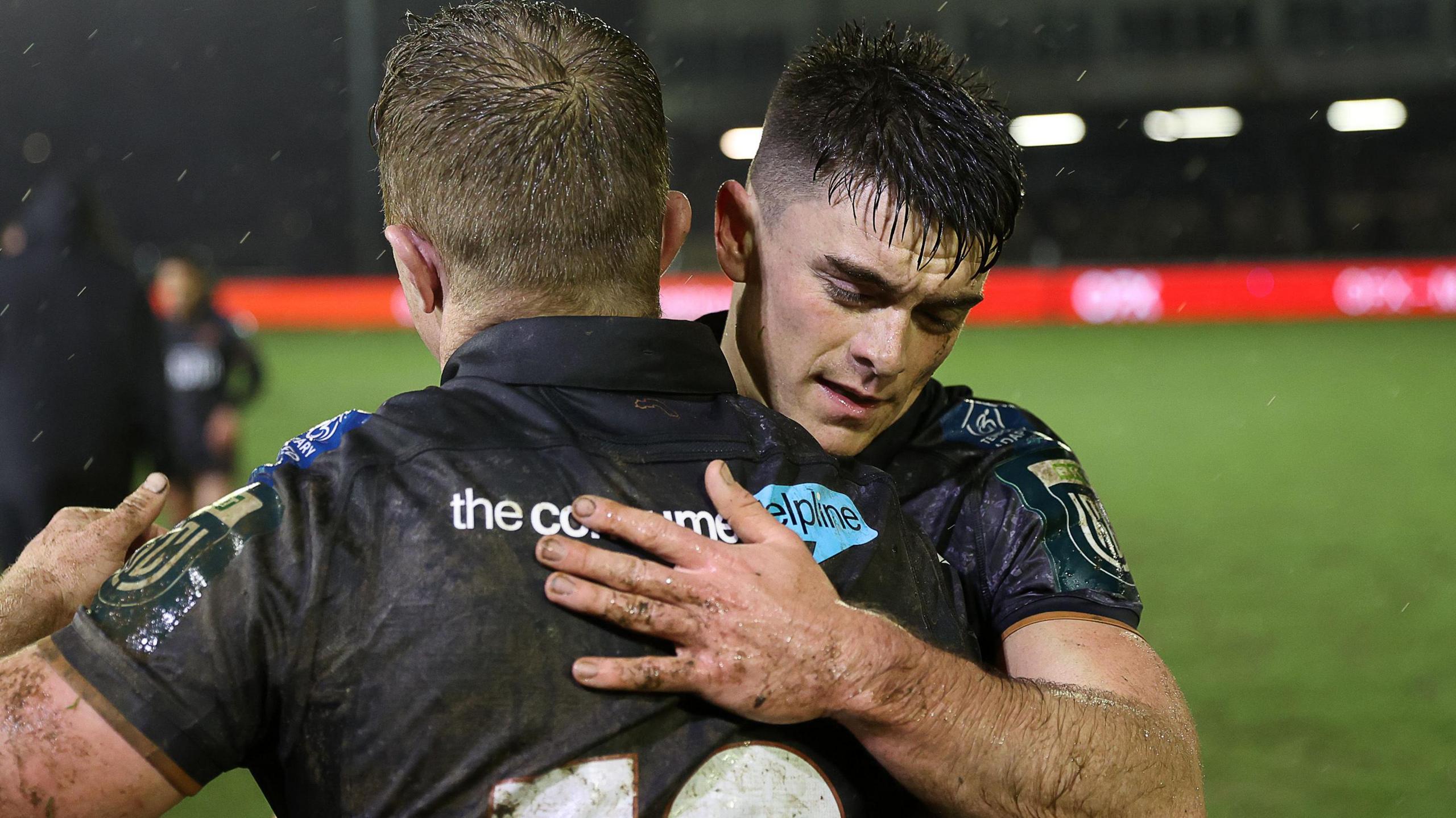 Ospreys scrum-half Reuben Morgan-Williams and Keiran Williams embrace