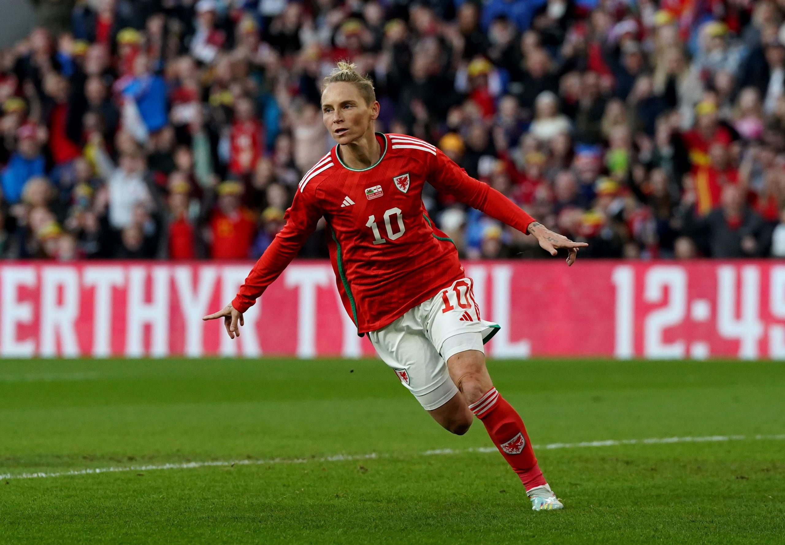 Jess Fishlock in the Wales red kit on a pitch