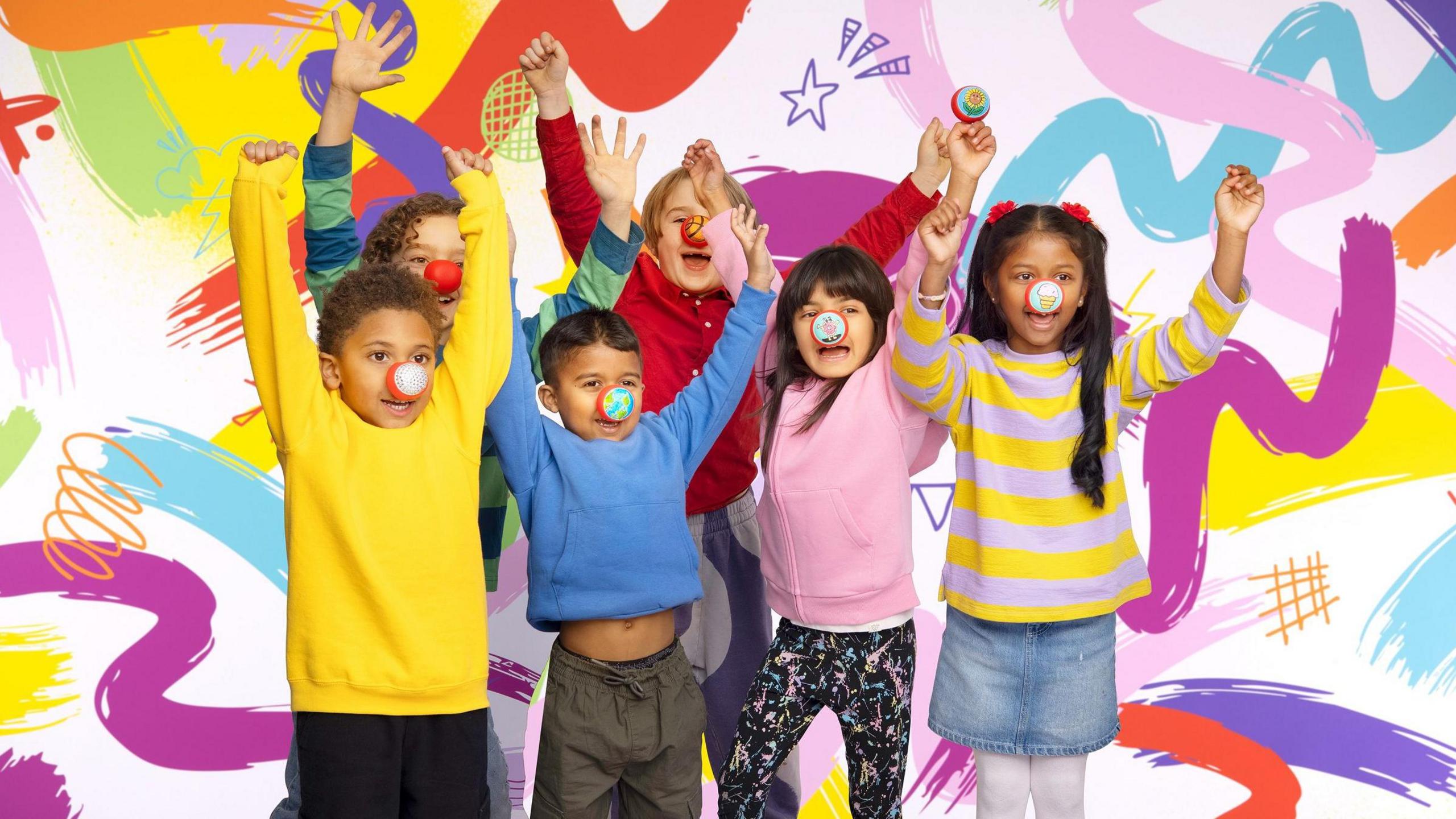 A promotional Comic Relief image showing six children of different ethnicities with their arms raised in the air while they have their red noses on. Behind them is an illustrated multicoloured background with stars, squiggles and spirals.