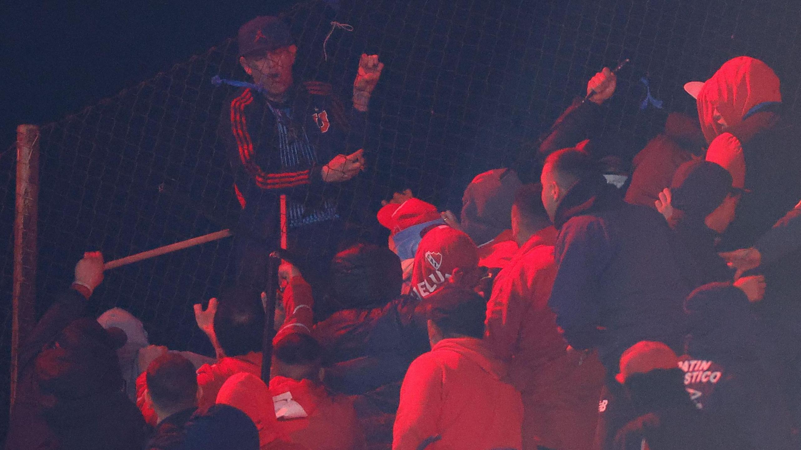 Rival fans clash at a Copa Sudamericana match between Independiente and Universidad de Chile in Buenos Aires