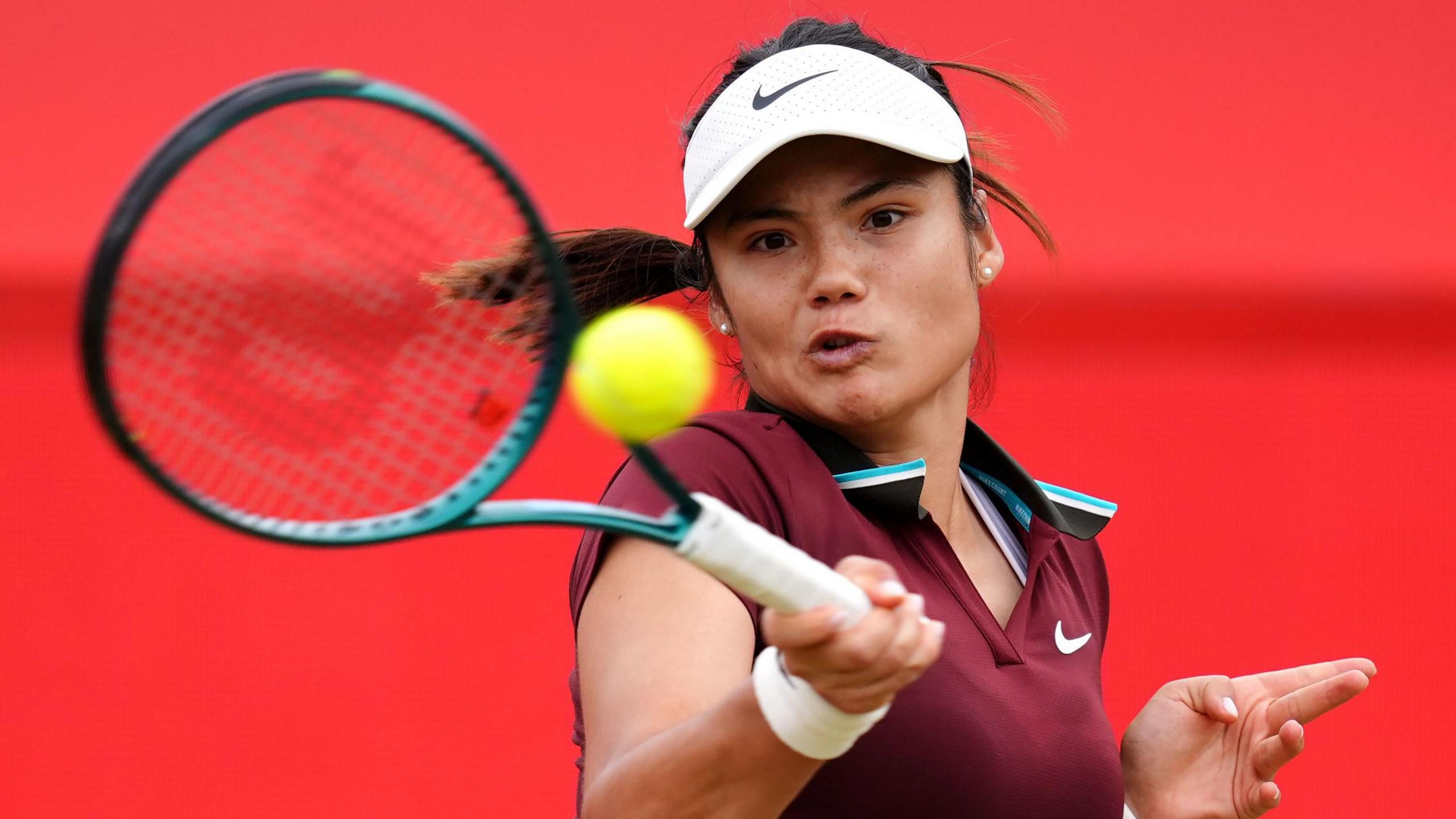 Emma Raducanu plays a stroke during her defeat by Zheng Qinwen