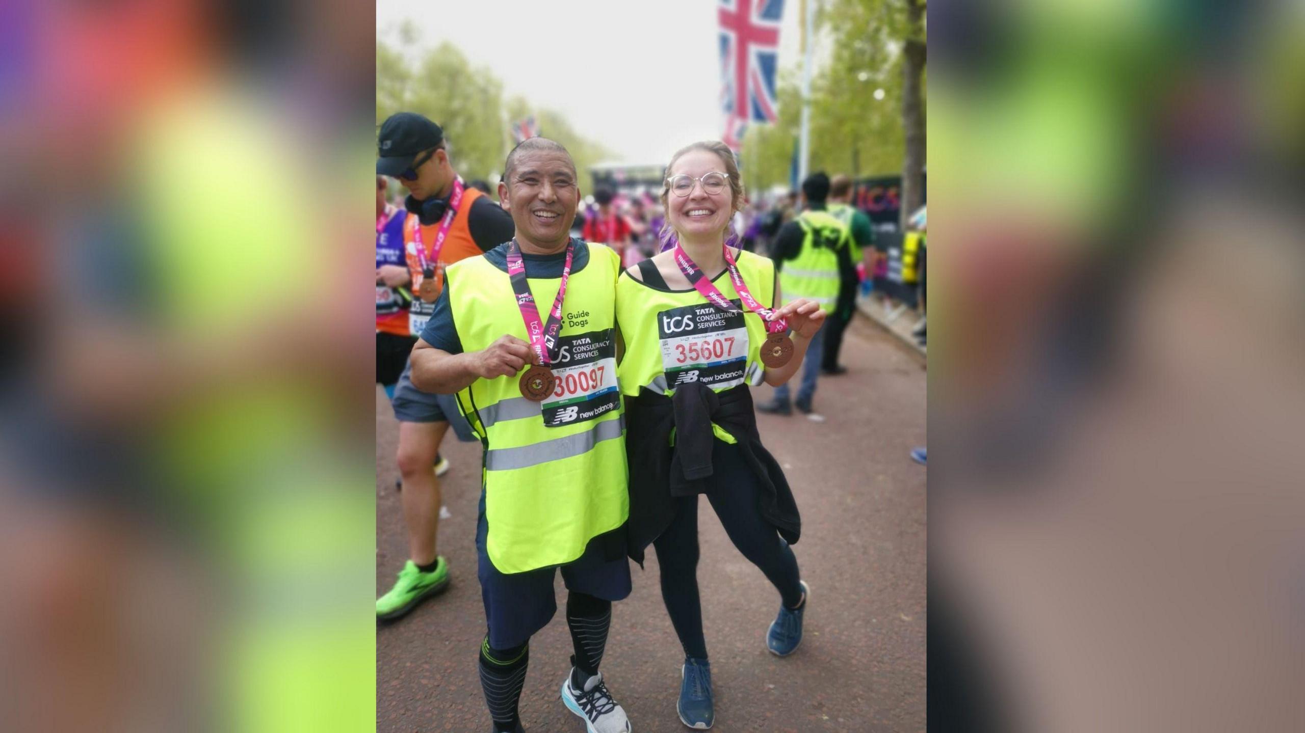 Karolina Pakenaite and her guide, Sammar Gurung wearing their medals at the finish line