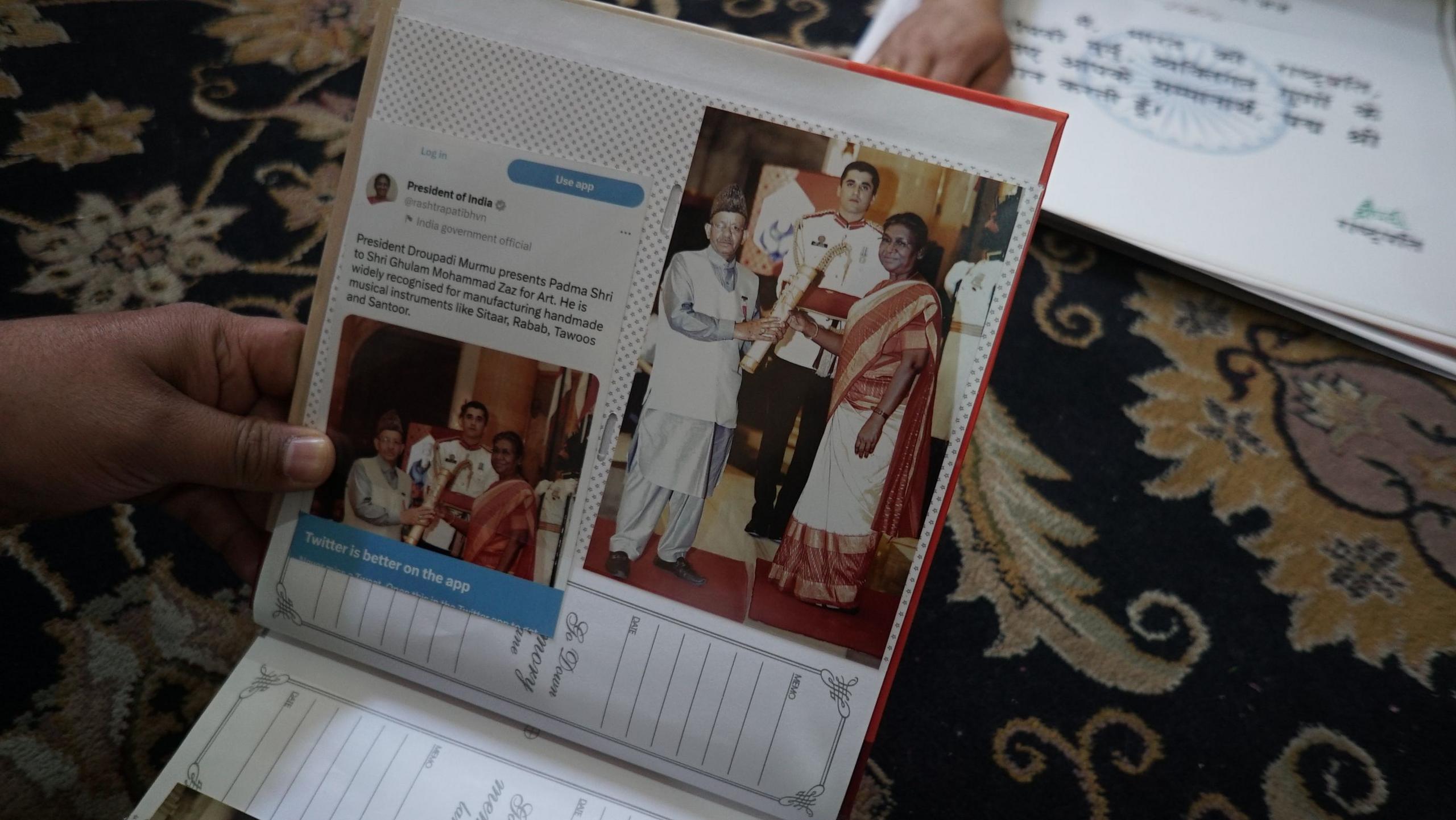 A photo album with a picture showing Ghulam Mohammed receiving the Padma Shri.
