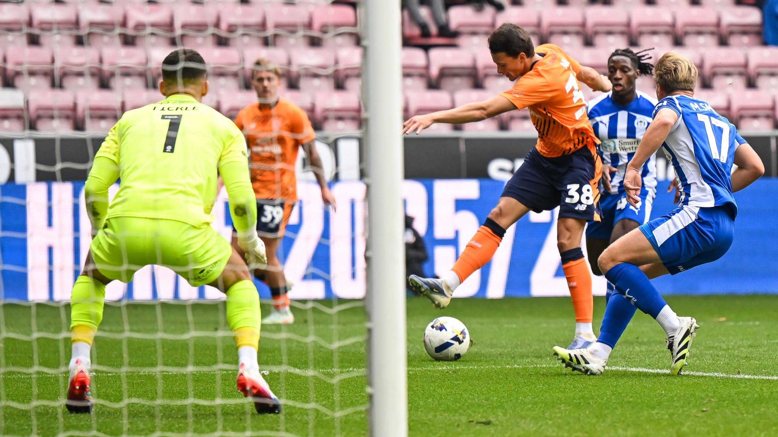Cardiff's Perry Ng unleashes a goal-bound shot against Wigan