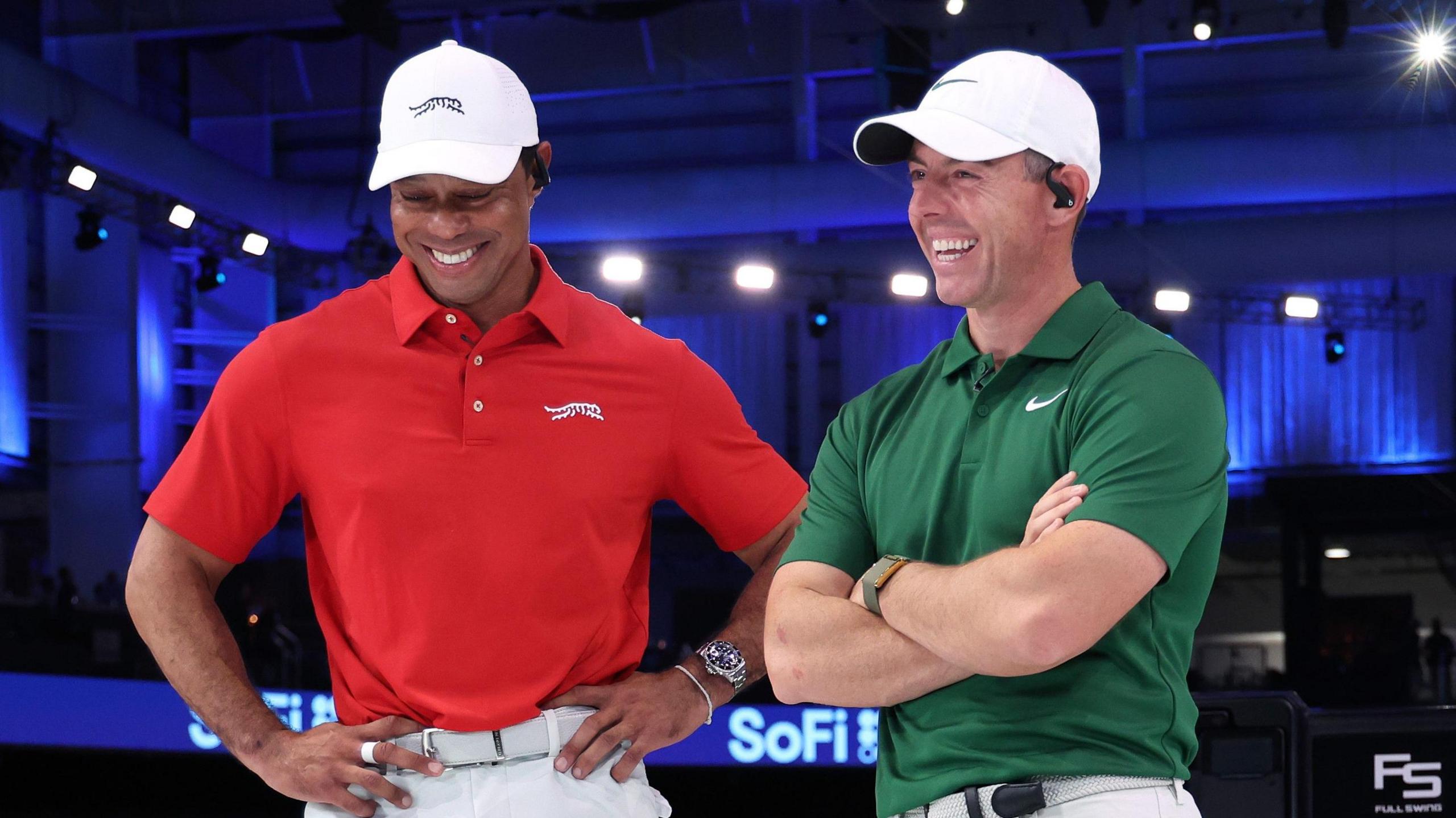 Tiger Woods and Rory McIlroy laughing 