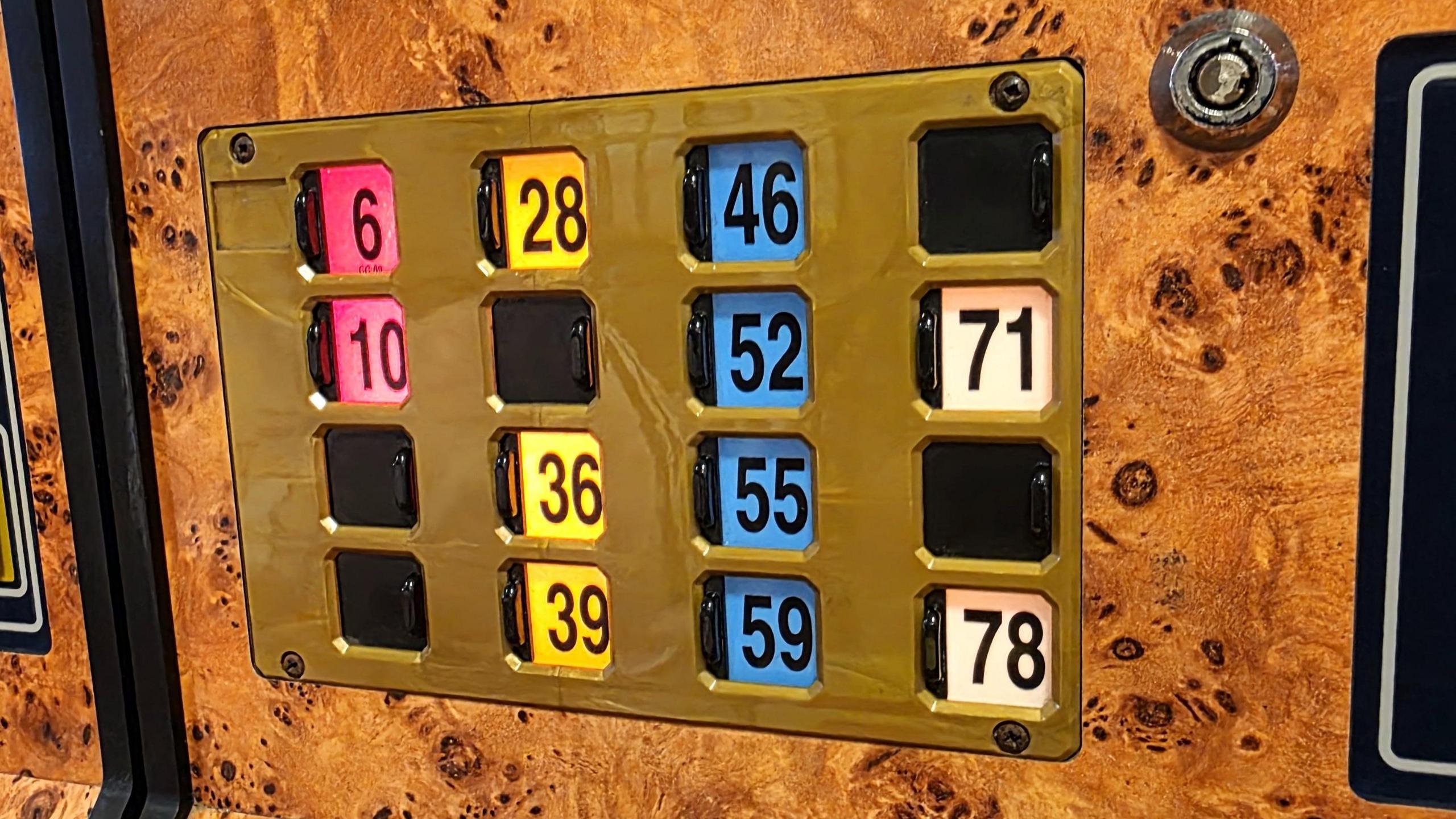 We can see a single bingo card with some of the numbers covered by plastic tabs