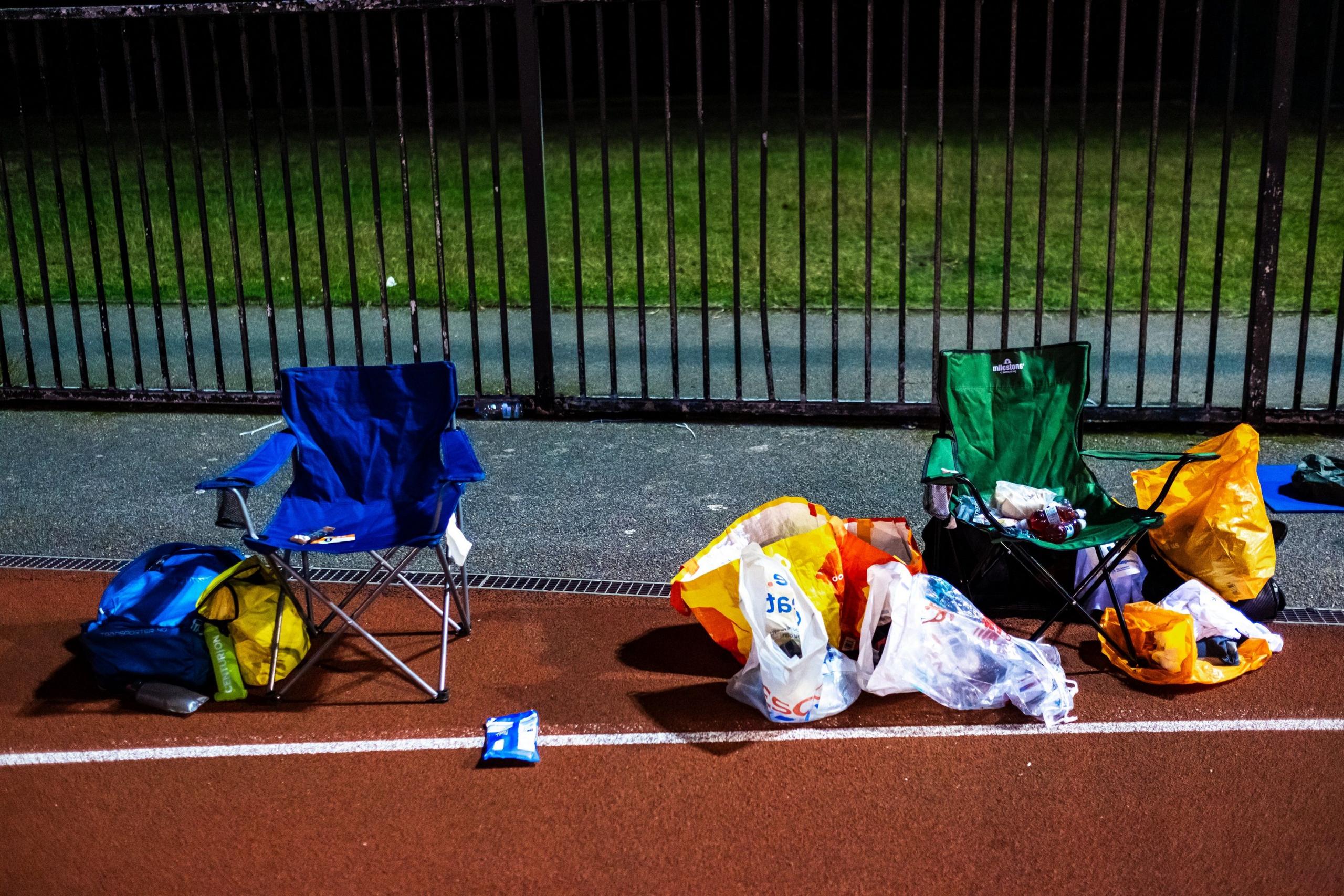 A camping chair and plastic bags on the side of the track at the Sri Chinmoy 24hr Track Race in Battersea