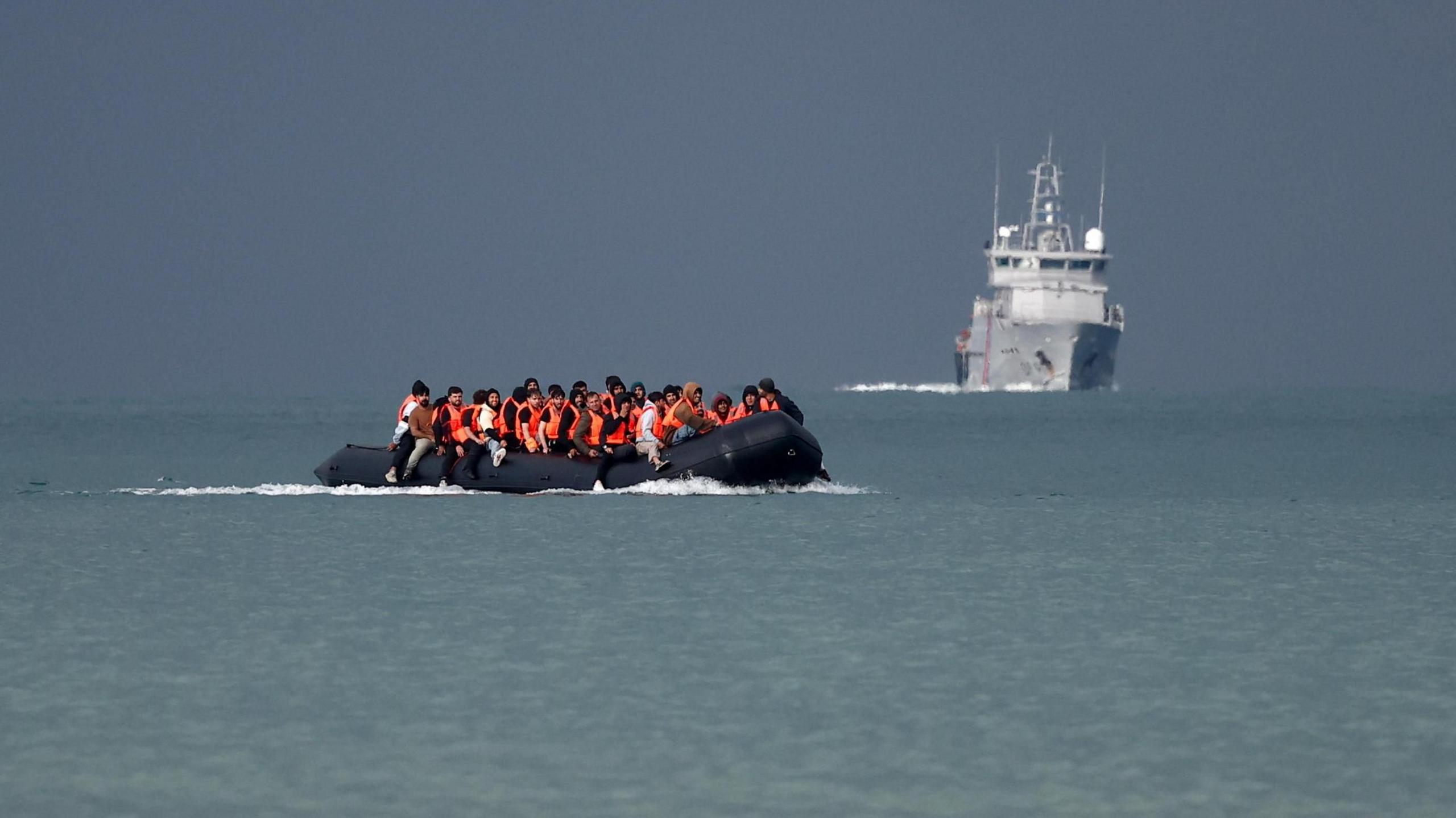 Migrants on an inflatable dinghy attempt to cross the English Channel to reach the UK.