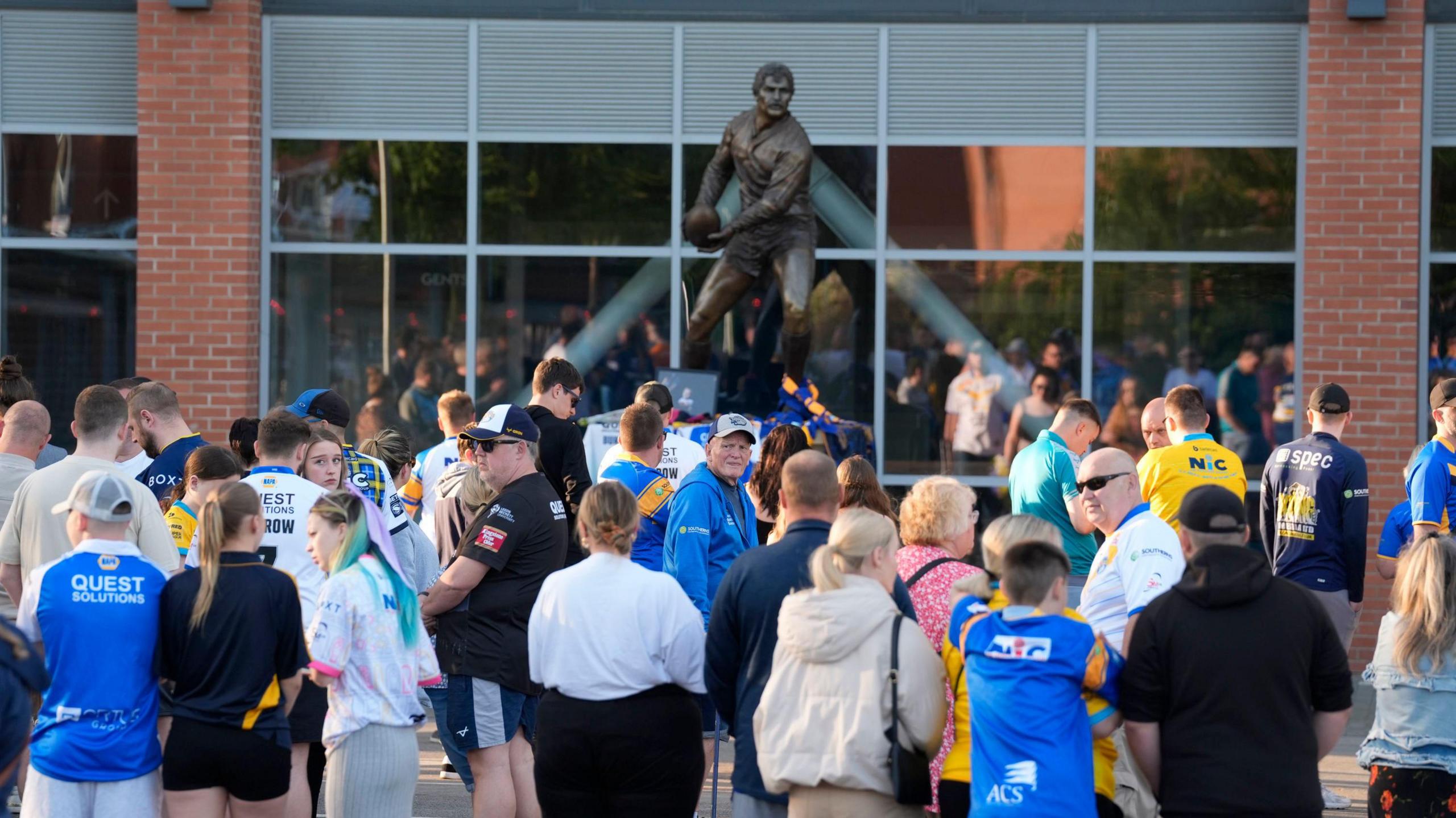 People gather around a statue 