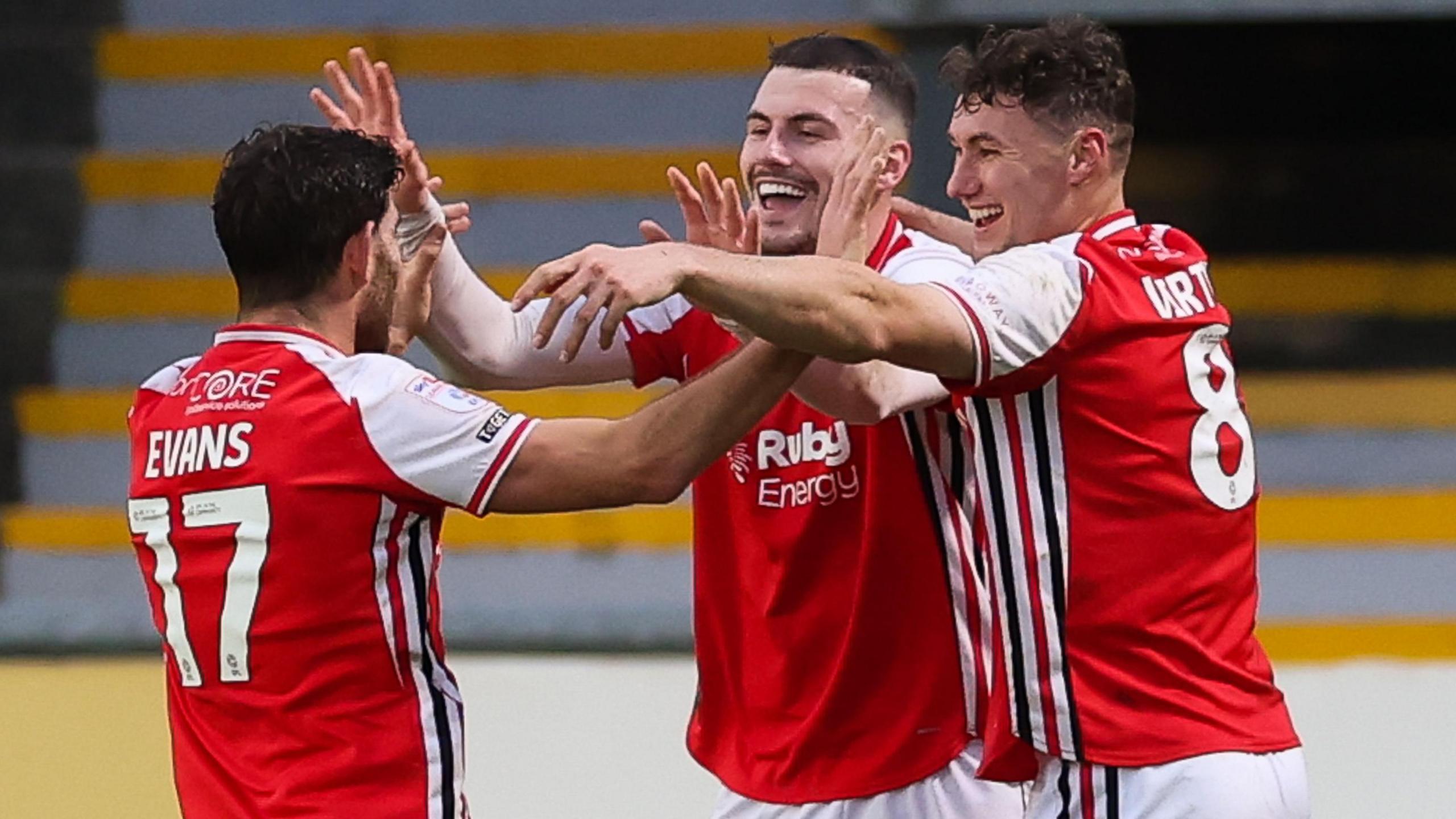 Fleetwood players celebrate their opening goal at Rodney Parade