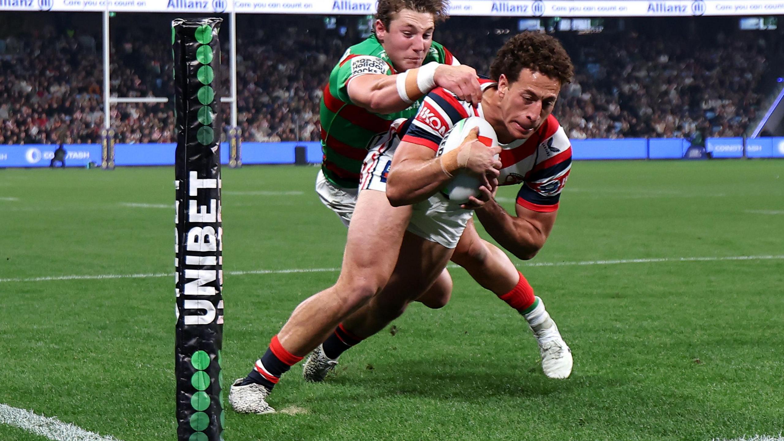 Mark Nawaqanitawase pushes past Jamie Humphries of the Rabbitohs to score in the corner for Roosters in the NRL derby of round 27.