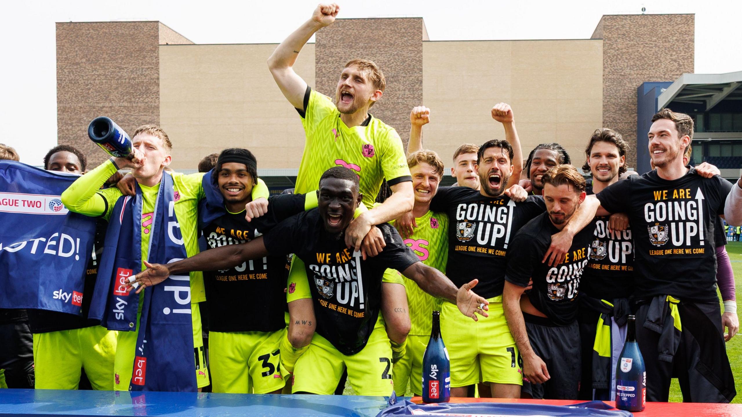 Port Vale players celebrate their promotion at full-time