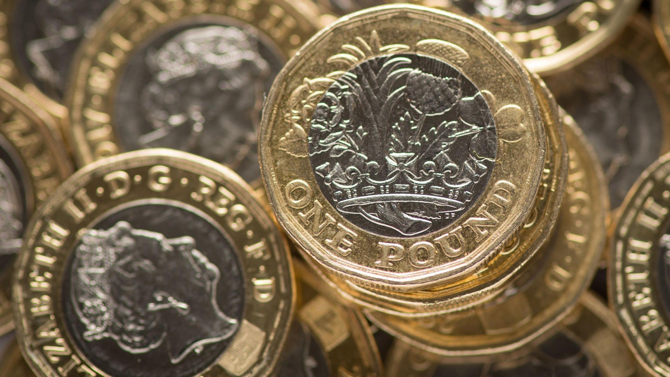 A pile of shiny £1 coins