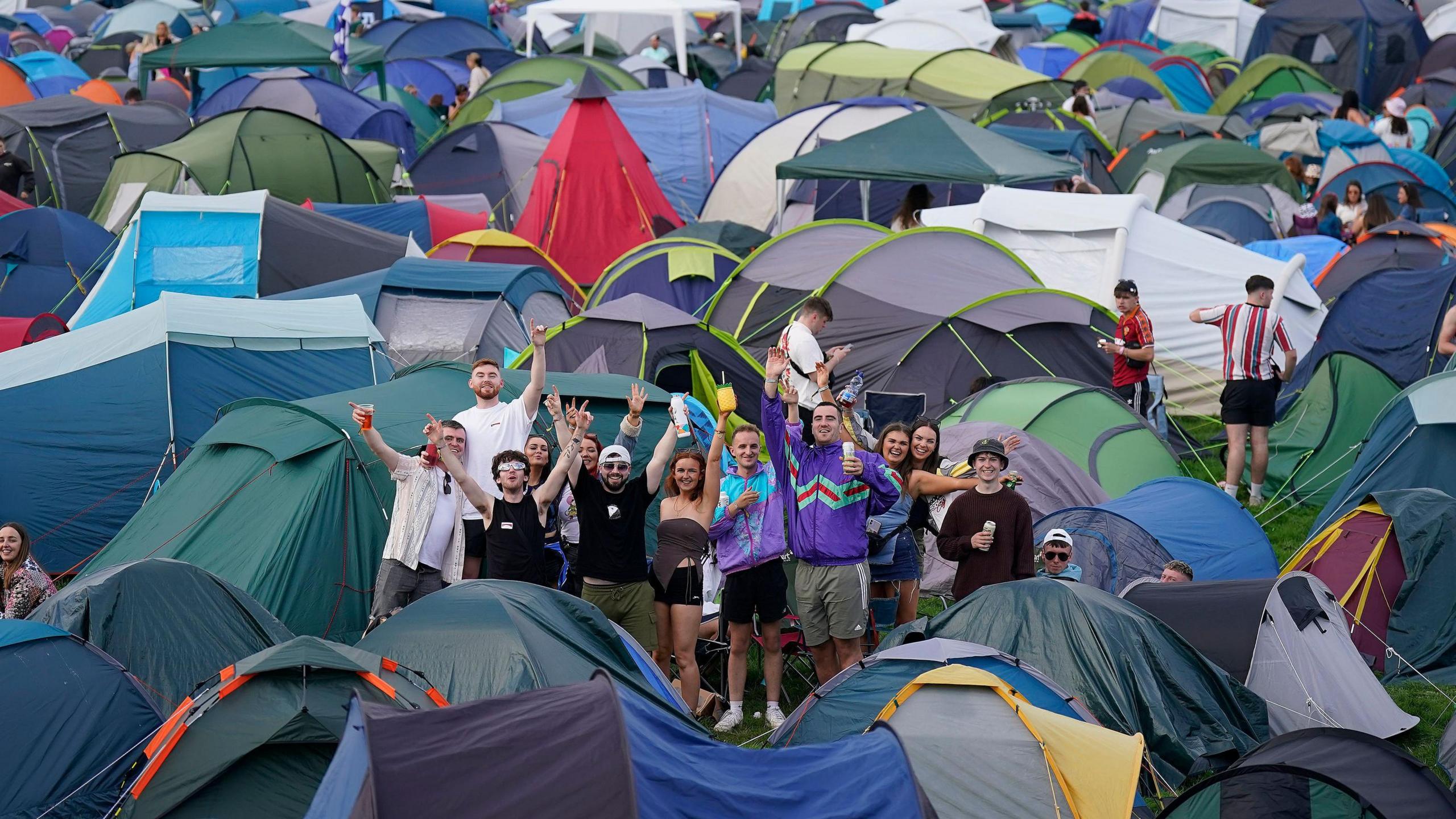 A group enjoying the campsite at Electric Picnic with a variety of multi-coloured tents