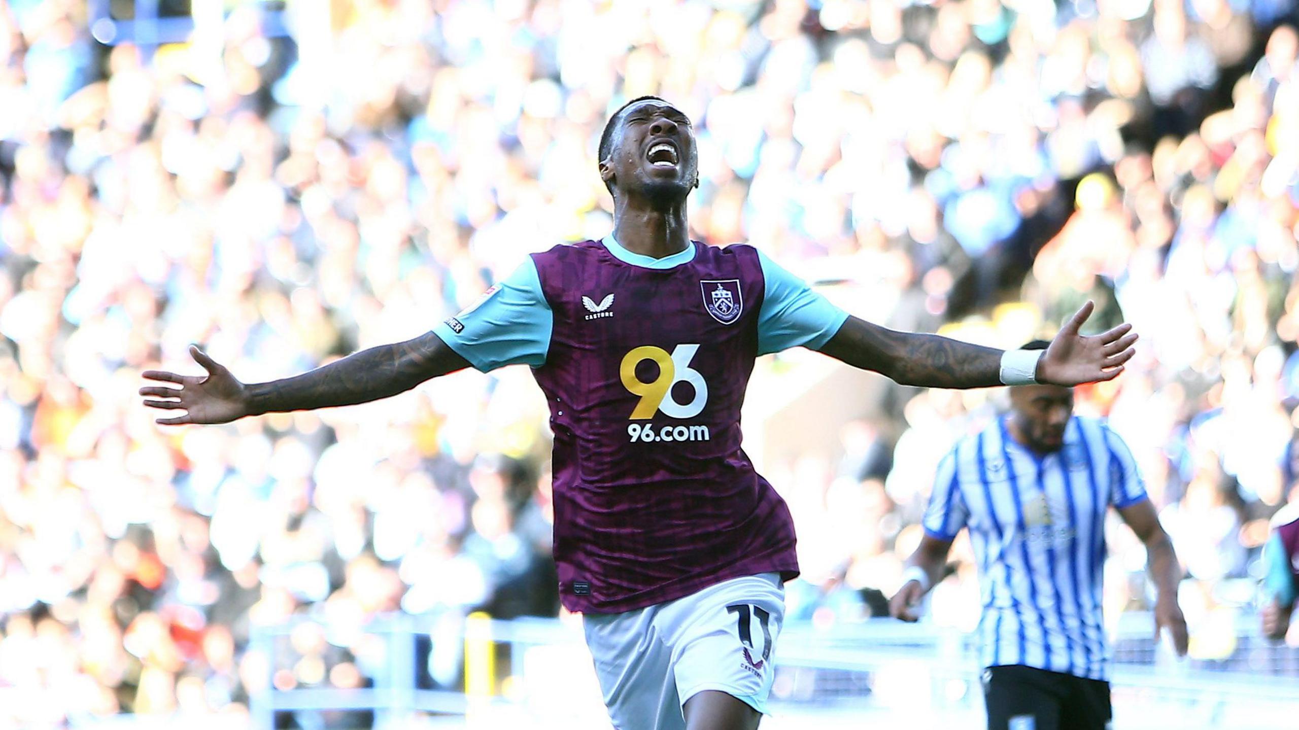 Jaidon Anthony celebrates with his arms wide apart after scoring for Burnley