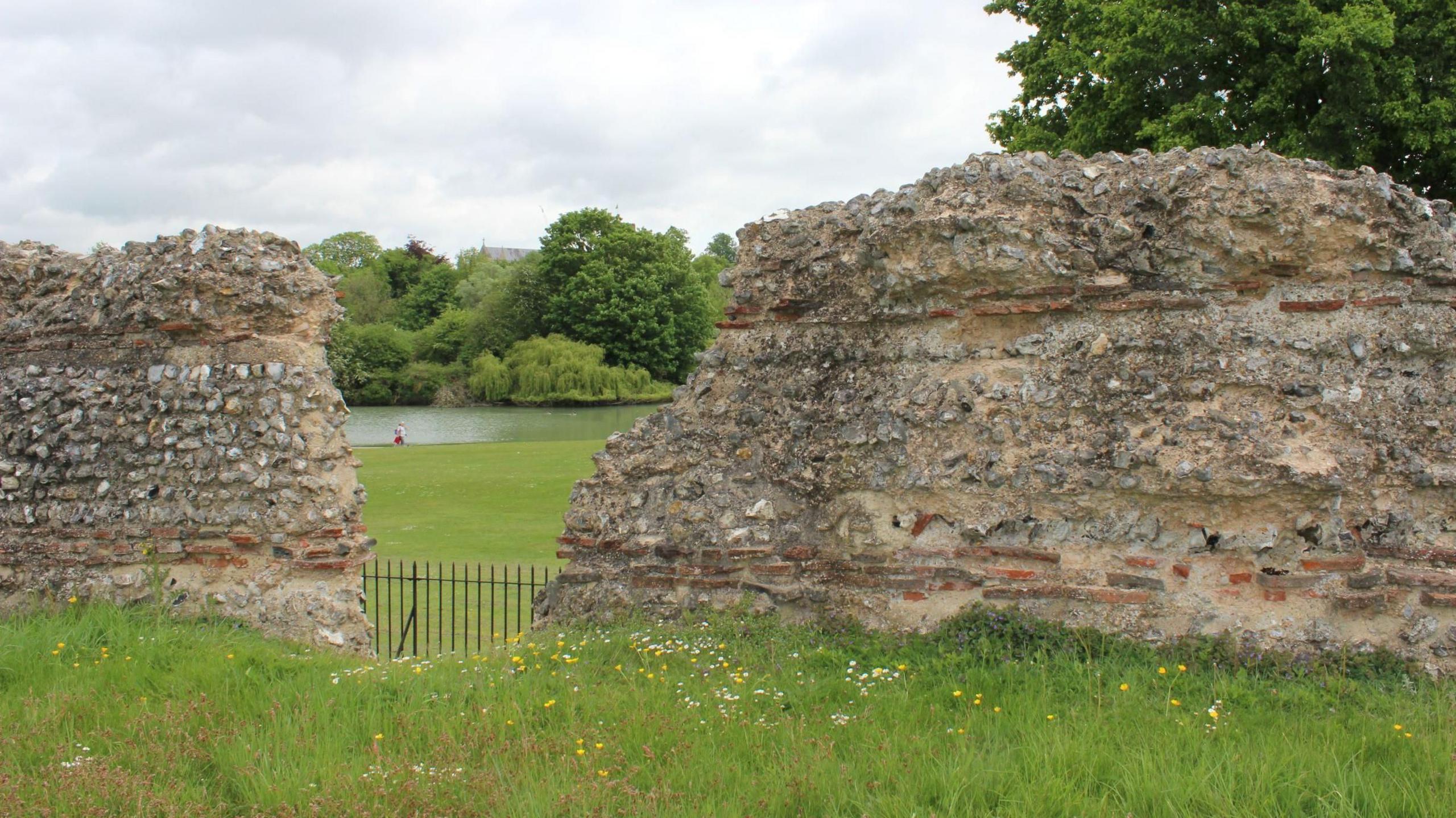Grass and a old stone wall, said to be Roman ruins, at Verulamium Park