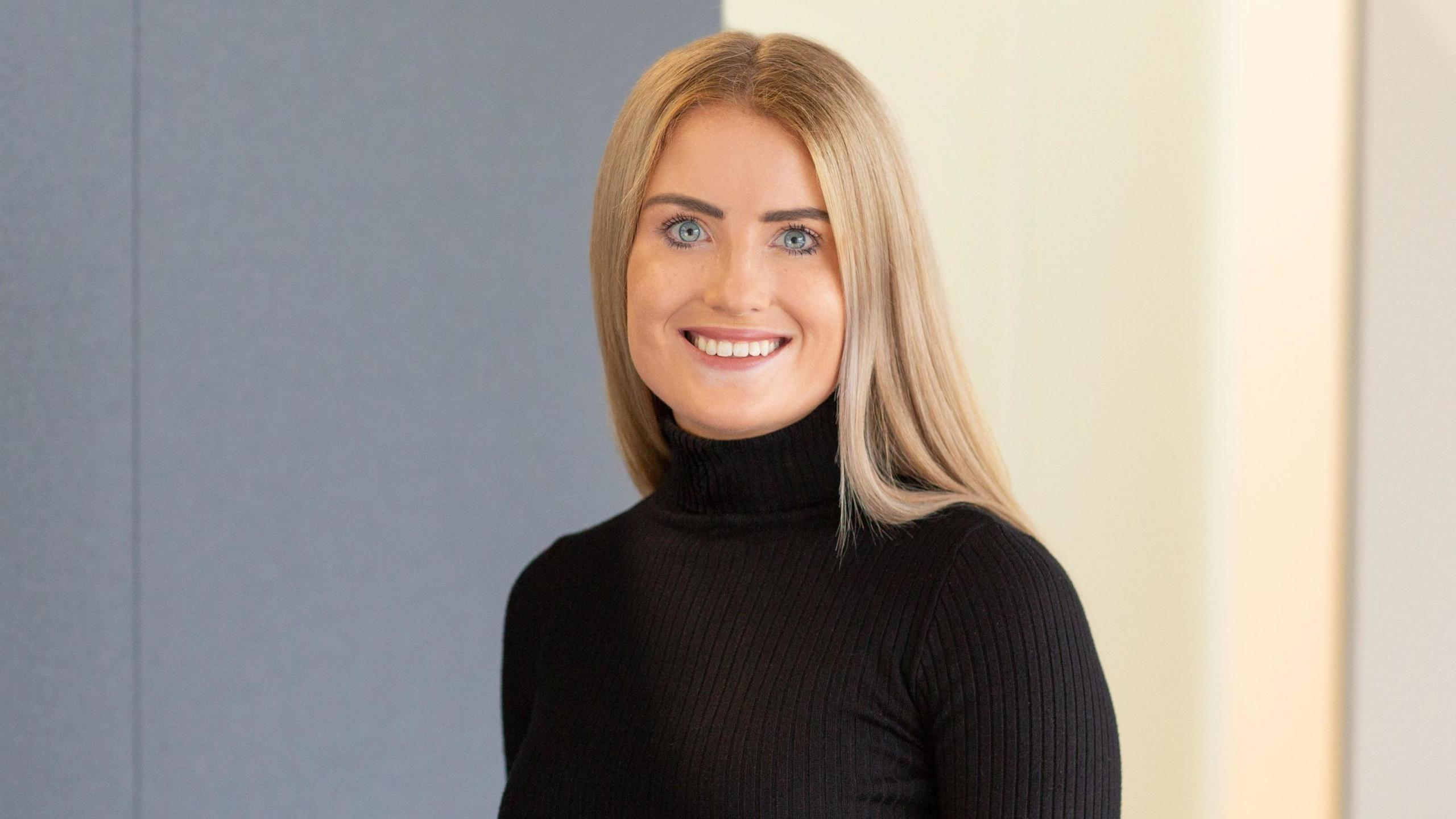 Head and shoulders shot of Simone White, a young woman with blonde hair 