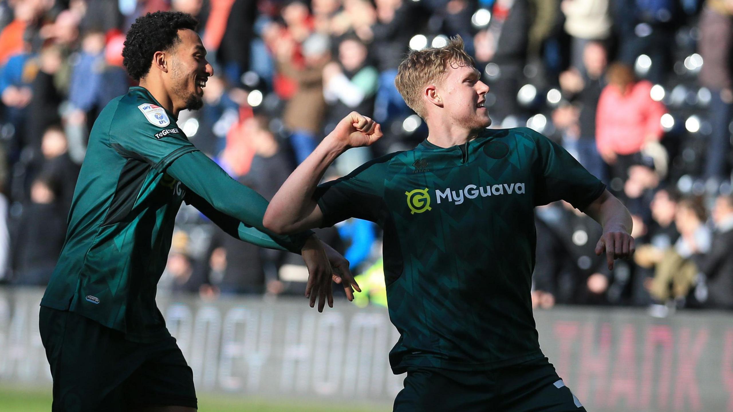 Josh Coburn celebrates with Millwall fans at full-time