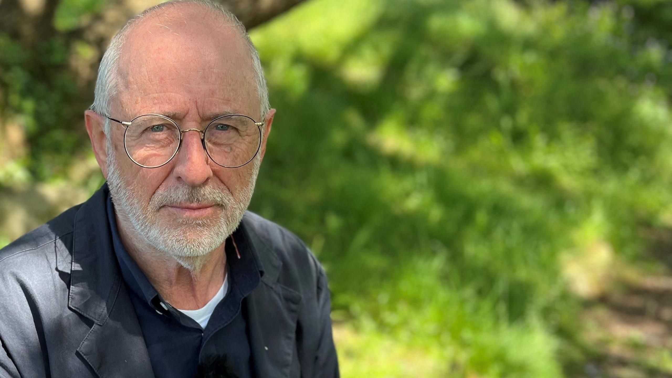 Steve Boulton wearing glasses in a park