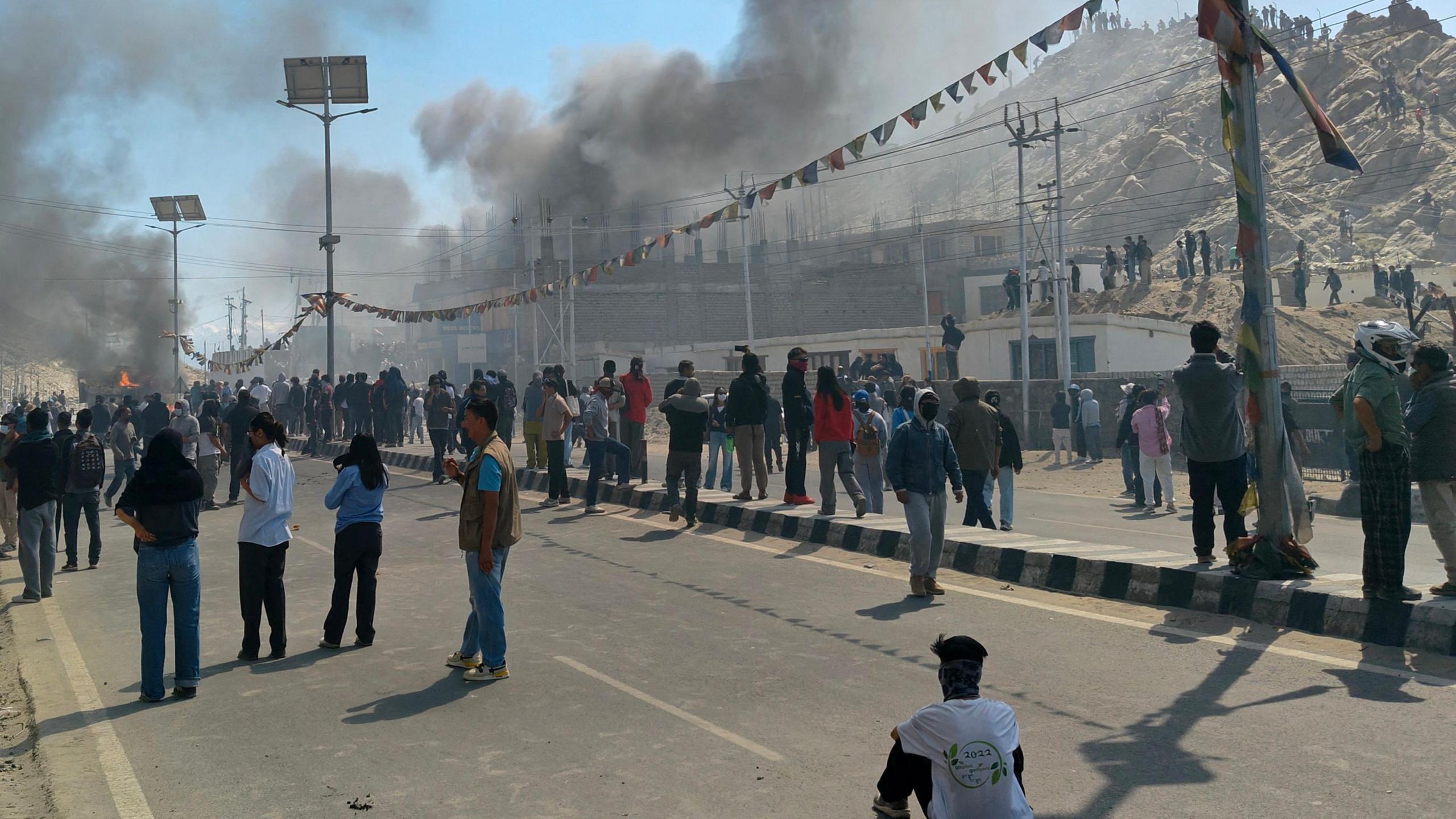 Smoke rises from a police vehicle that was torched by the demonstrators near the Bharatiya Janata Party (BJP) office in Leh on September 24, 2025.