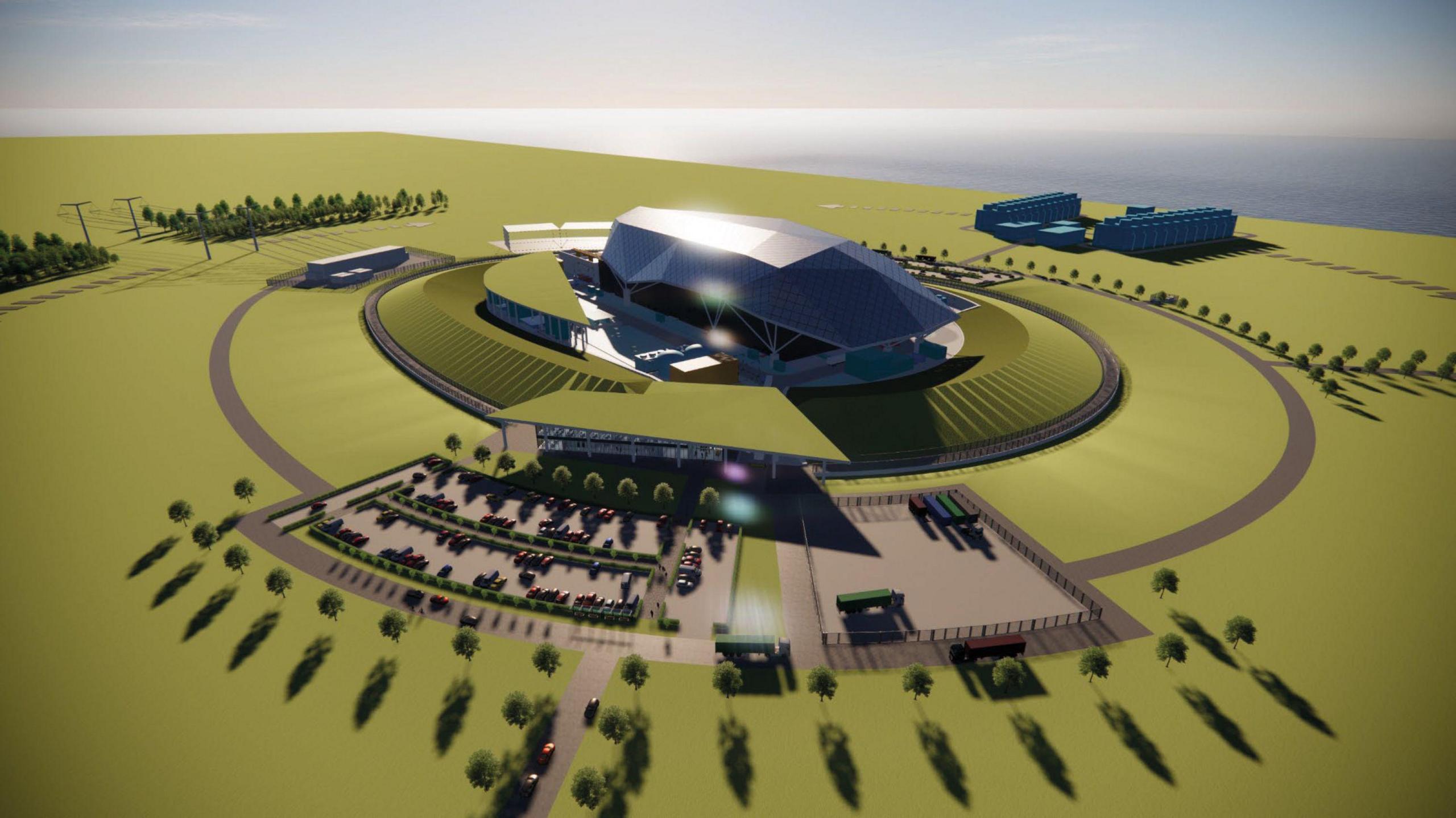 An computer generated artists impression of the what the site will look like. A silver building surrounded by green area, trees and a car park which sits in front of it.