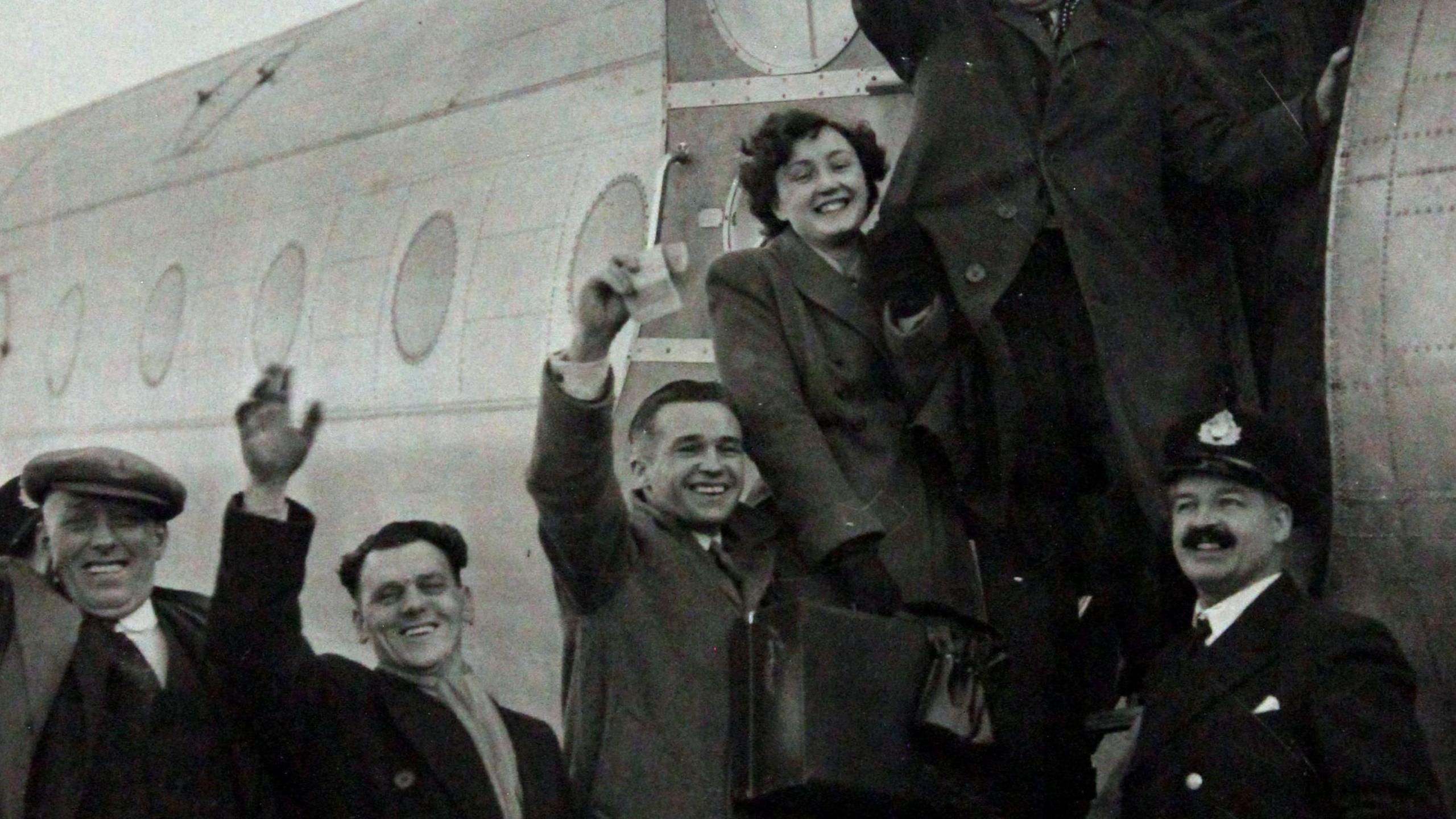 Passengers including Dai and Kathleen Hawkins from Llanharan waving as they board the Avro Tudor aircraft on its way to Ireland.