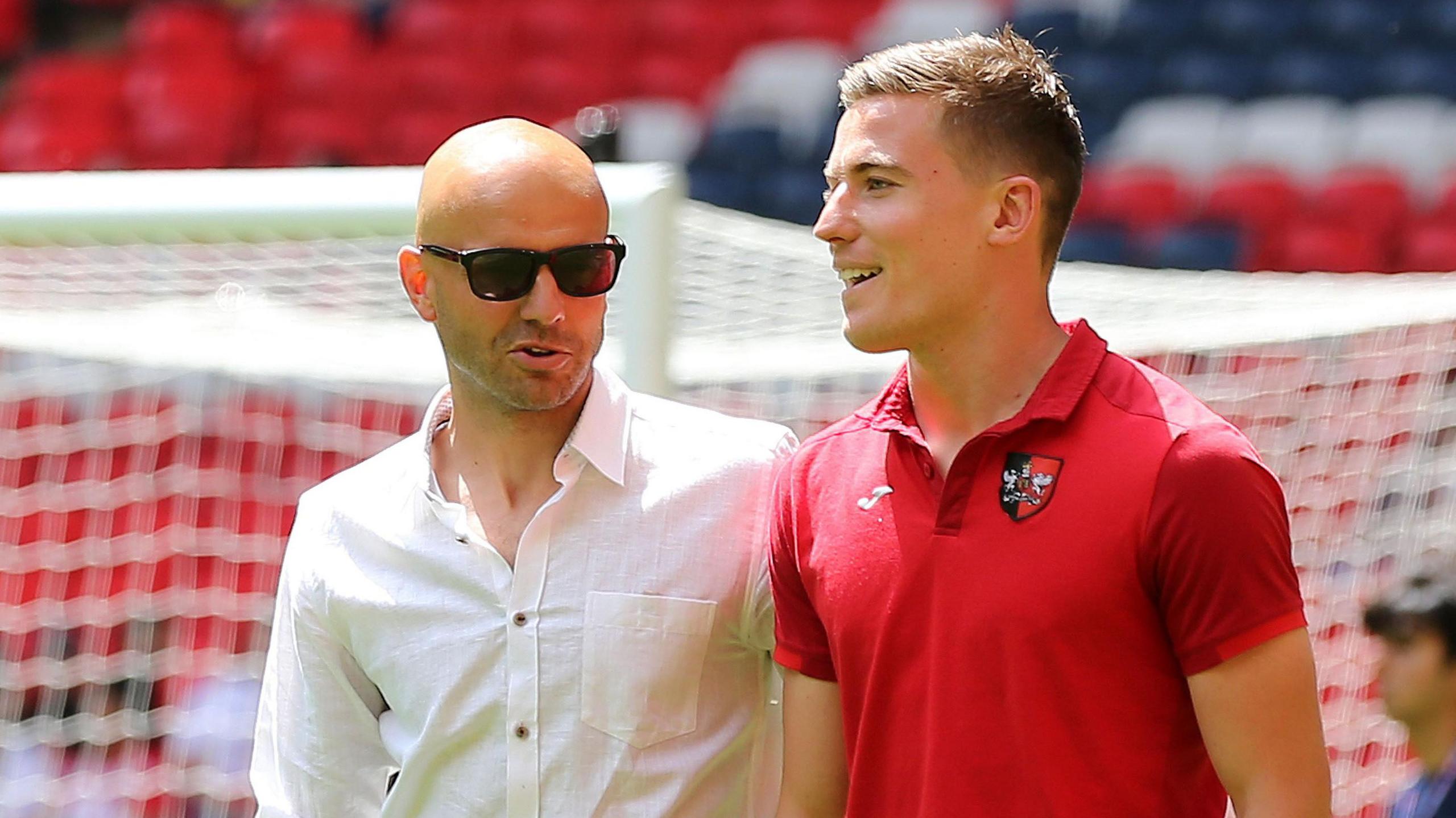 Paul Tisdale and David Wheeler talk at the side of the pitch