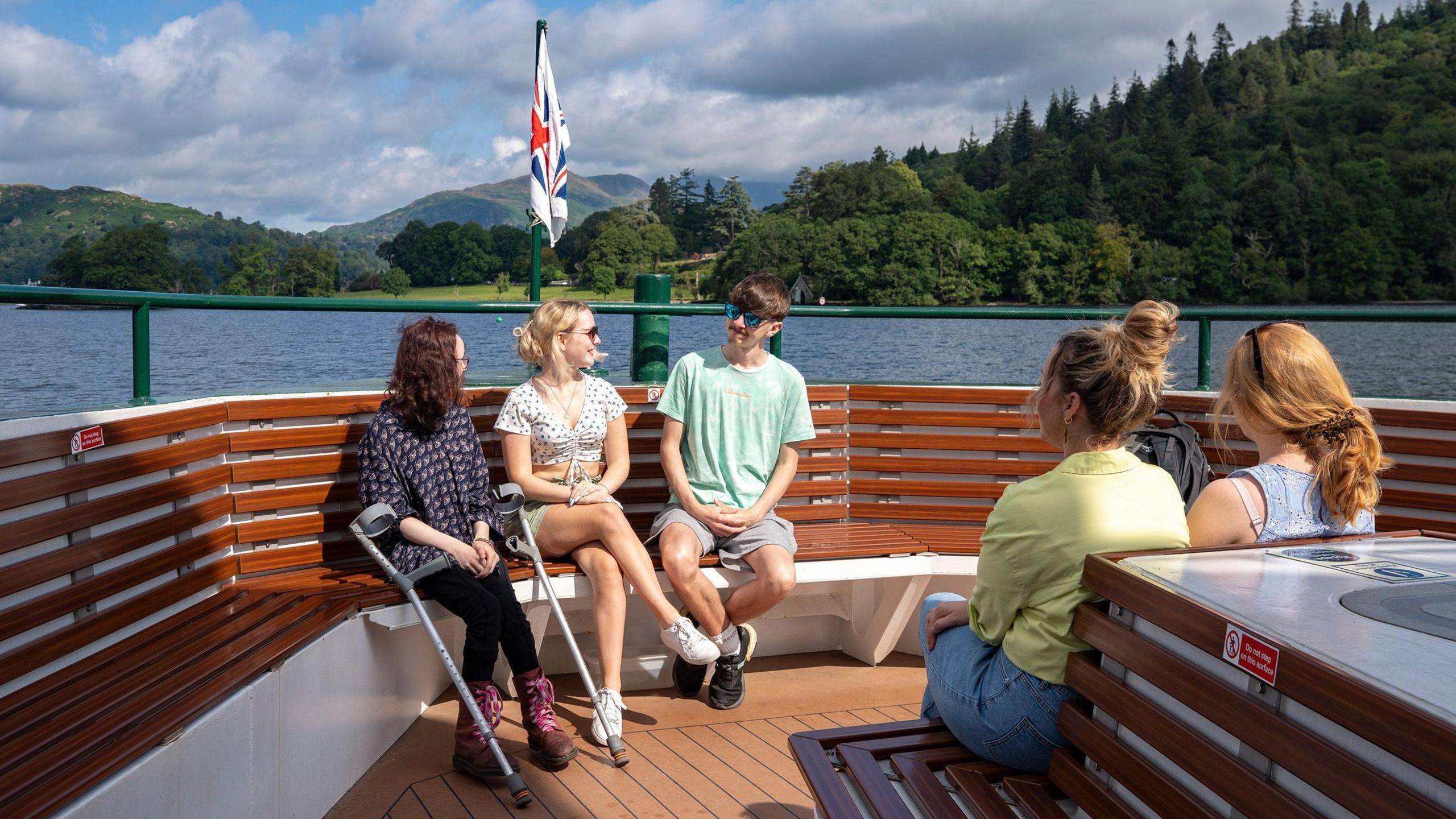 Five young people on a boat on a sunny day