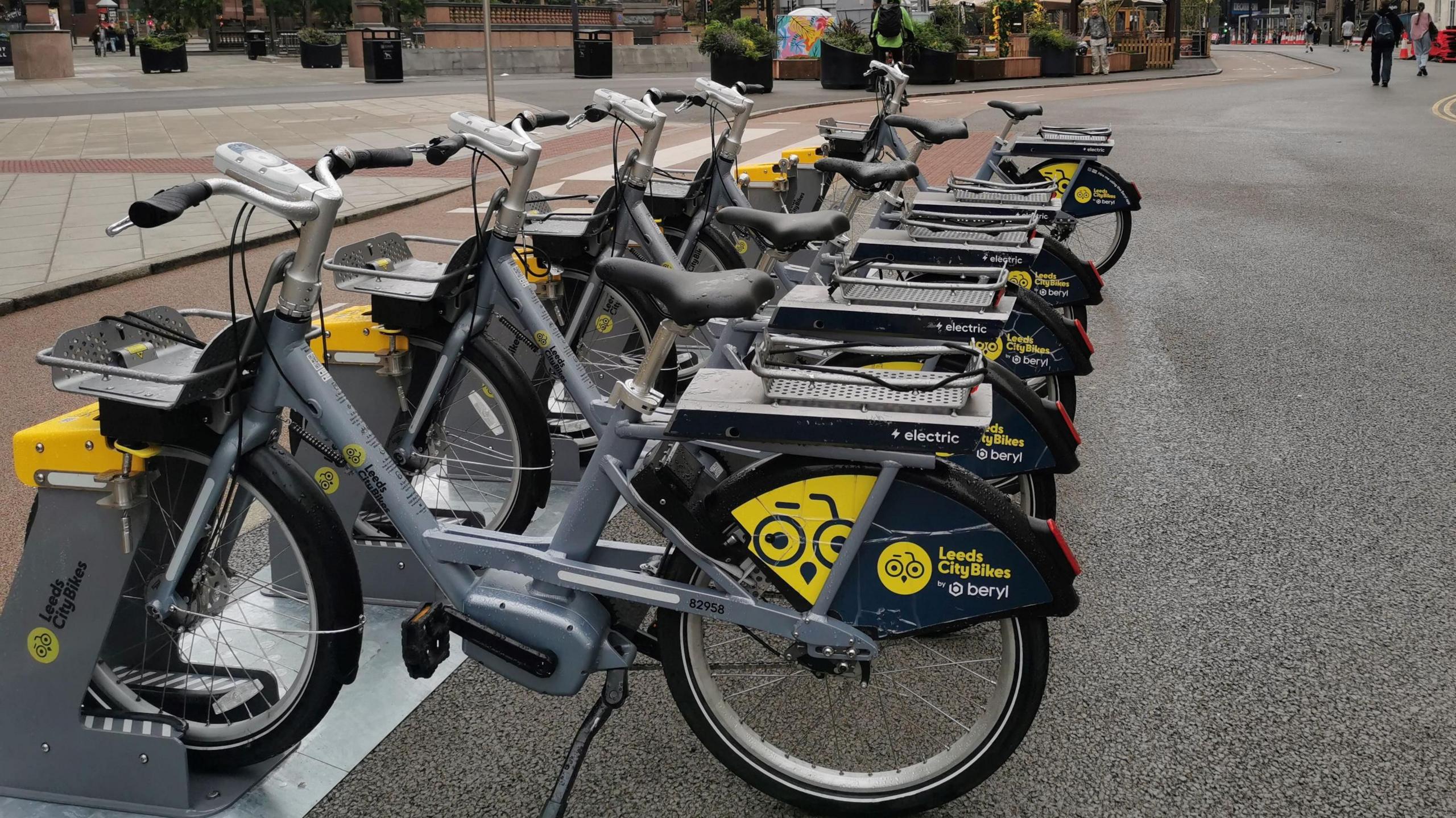 A row of e-bikes in the street 