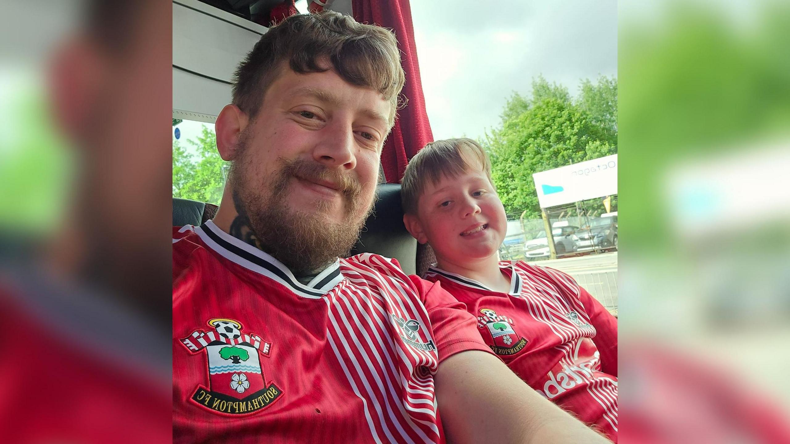 father and son on coach wearing Saints tops